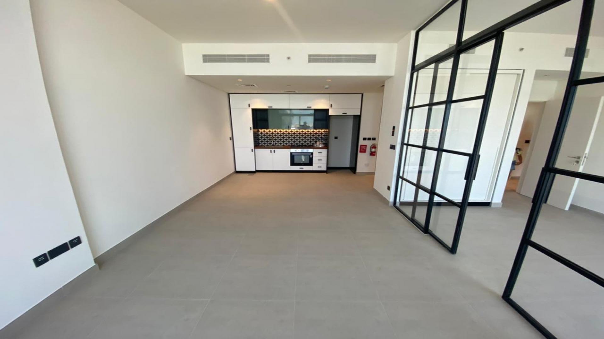 "Bright living room in Dubai Hills apartment with large windows and pool view.",Modern kitchen in Dubai Hills 2-bedroom apartment, open layout, sleek design, Collective community