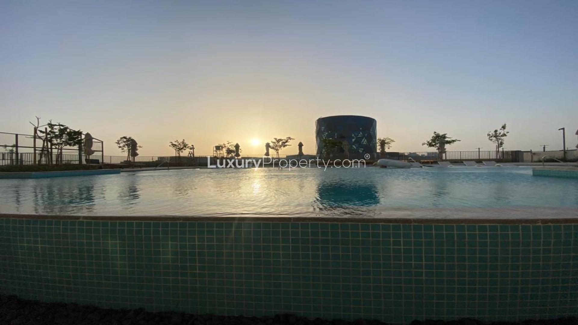 Dubai Hills Estate apartment pool view at sunset, Dubai Hills Collective community