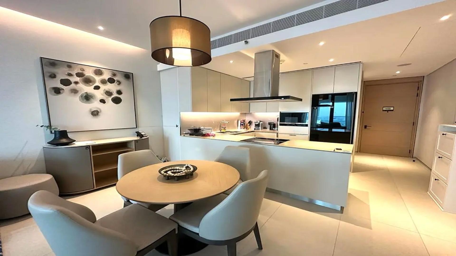 "Luxury Jumeirah Beach Residence apartment living room with sea view and modern decor.",Modern kitchen and dining area in luxury Jumeirah Beach Residence apartment, The Address Jumeirah
