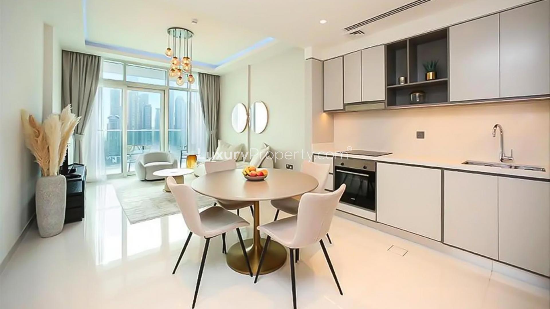 "Modern living room with large balcony, Emaar Beachfront apartment, Dubai Harbour, for rent.",Modern kitchen and dining area with large windows in Emaar Beachfront apartment, Dubai Harbour