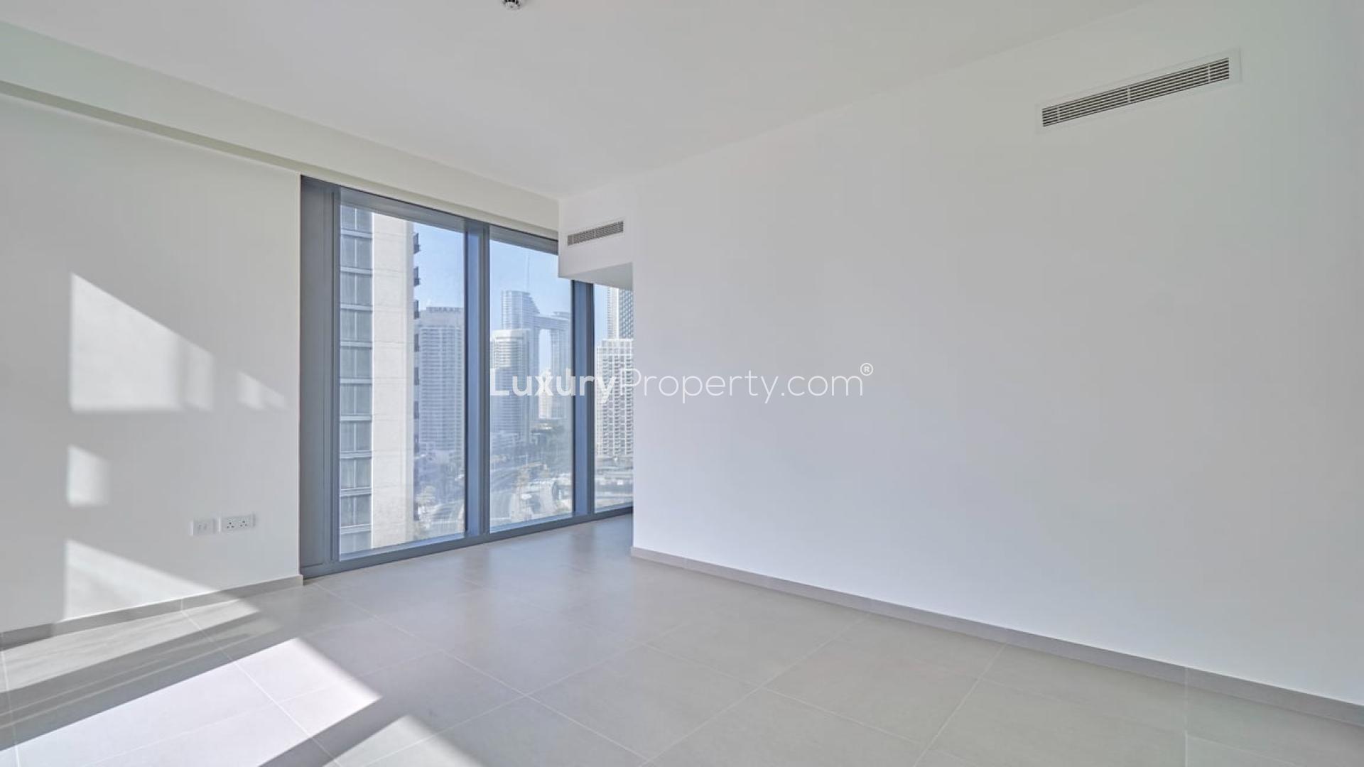 Bright, empty room with large windows in Downtown Dubai apartment, BLVD Heights view
