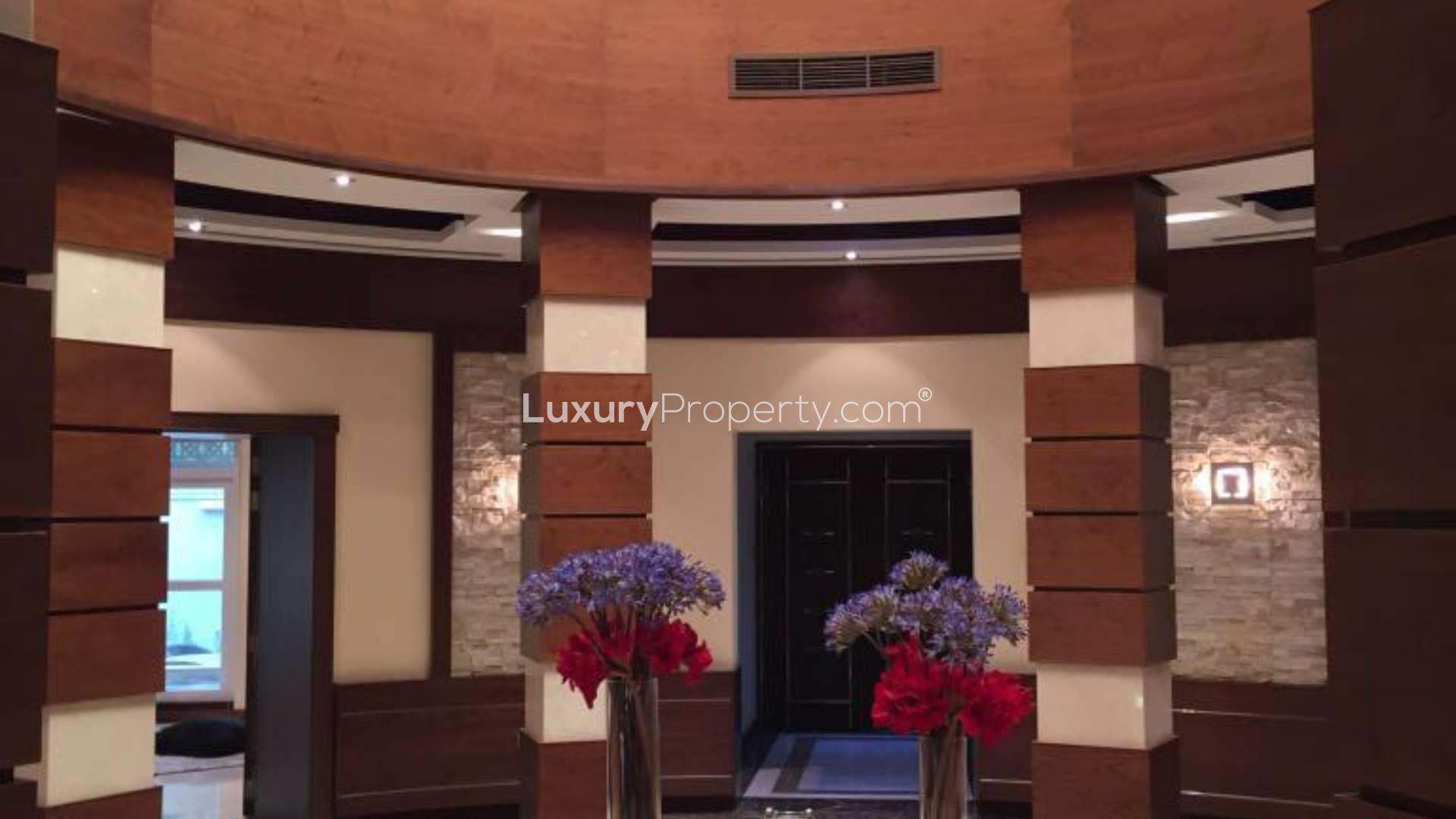 Interior view of luxury apartment lobby in Burj Khalifa, featuring elegant wood and stone design