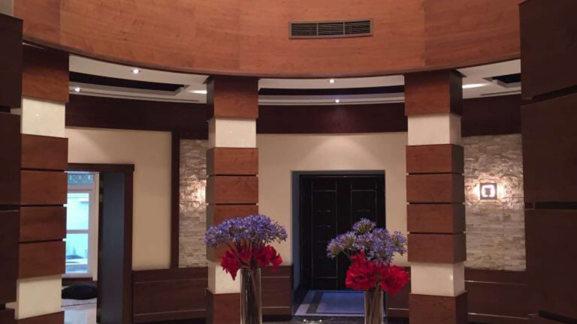 Interior view of luxury apartment lobby in Burj Khalifa, featuring elegant wood and stone design