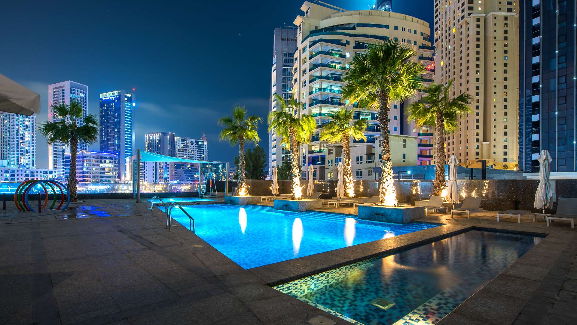 Stunning night view of Jumeirah Beach Residence waterfront with illuminated skyscrapers and marina