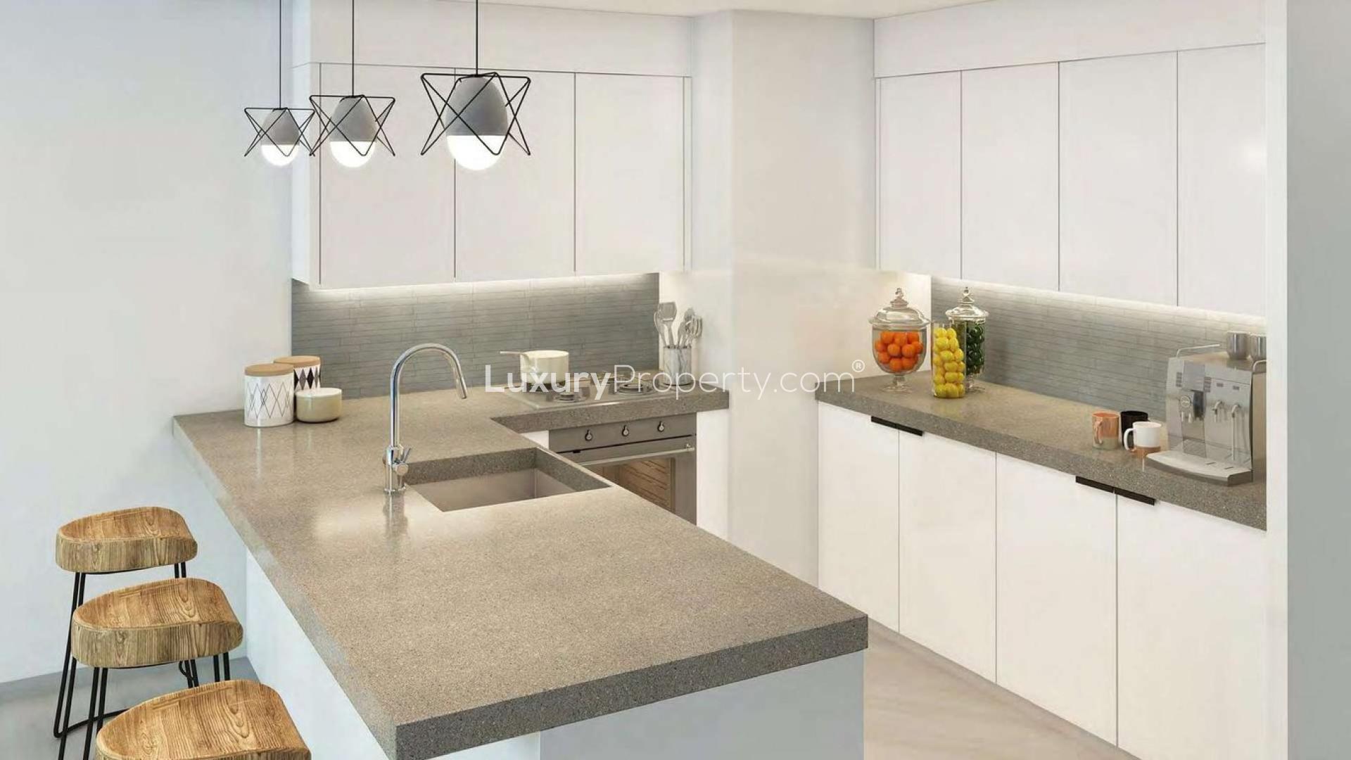 Modern kitchen with sleek countertops in Remraam one-bedroom luxury apartment, Dubailand