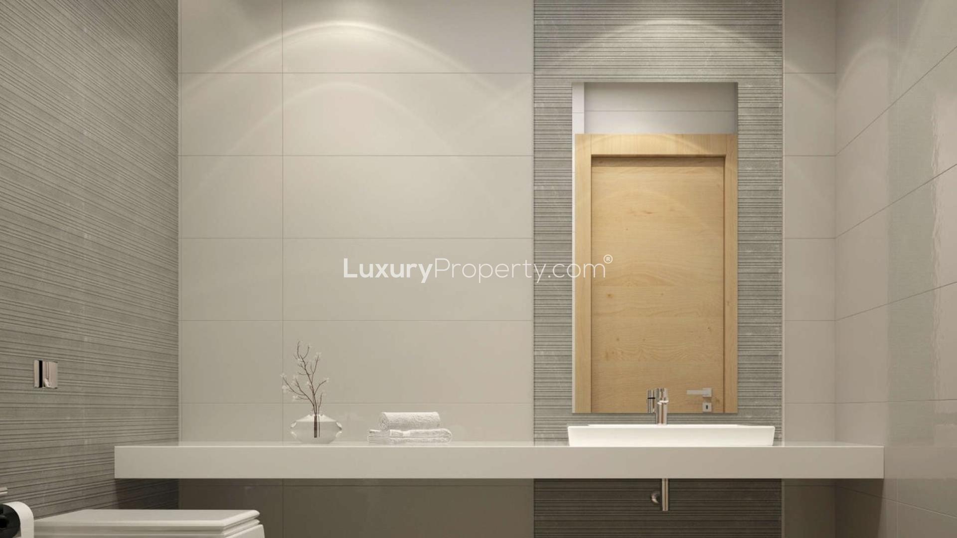 Contemporary bathroom in Studio 101 apartment, Dubai Studio City, featuring modern fixtures and design