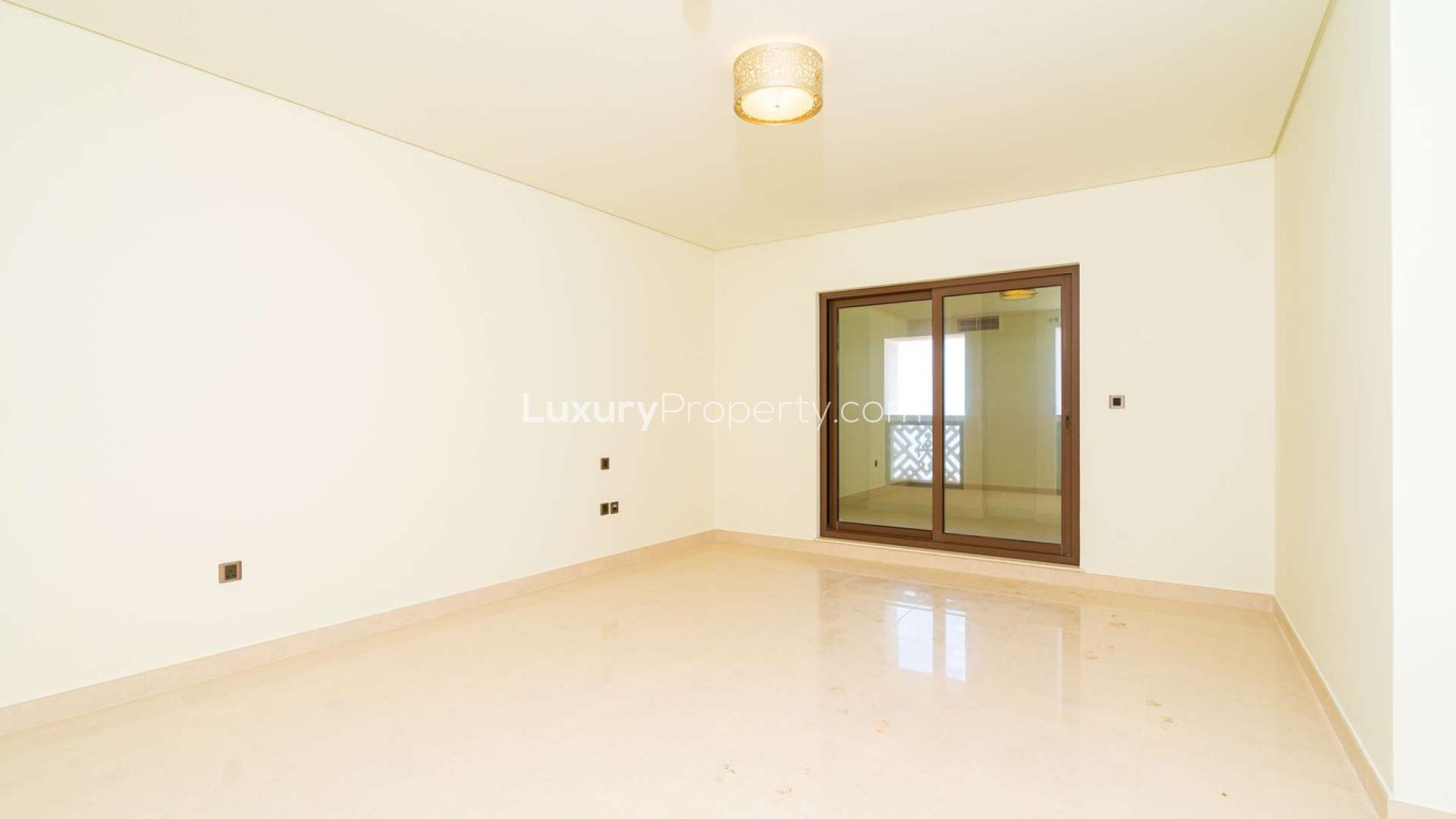 Modern kitchen in 2-bedroom apartment, Balqis Residence, Palm Jumeirah, featuring dark wood cabinets