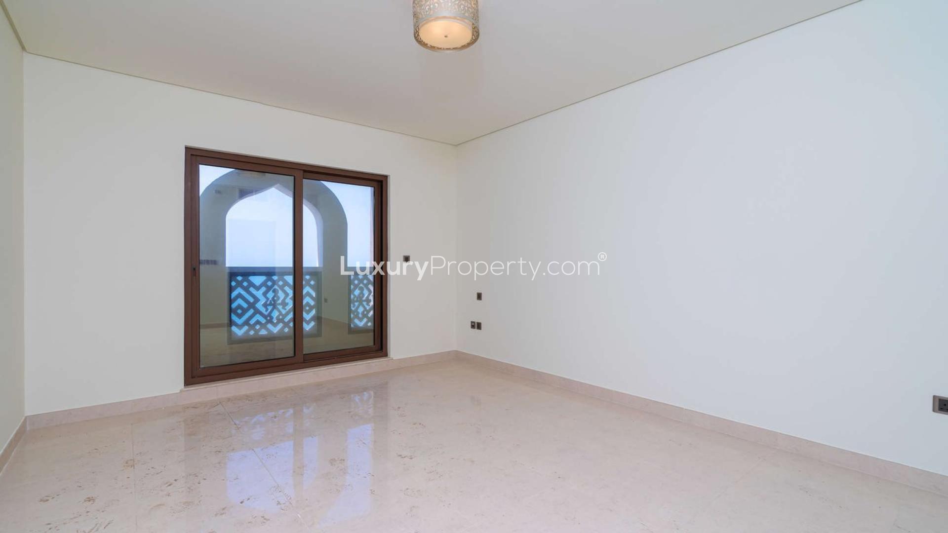 "Stunning sea view from Balqis Residence apartment, Palm Jumeirah, Kingdom of Sheba community.",Empty room with balcony view in Balqis Residence, Palm Jumeirah apartment for sale