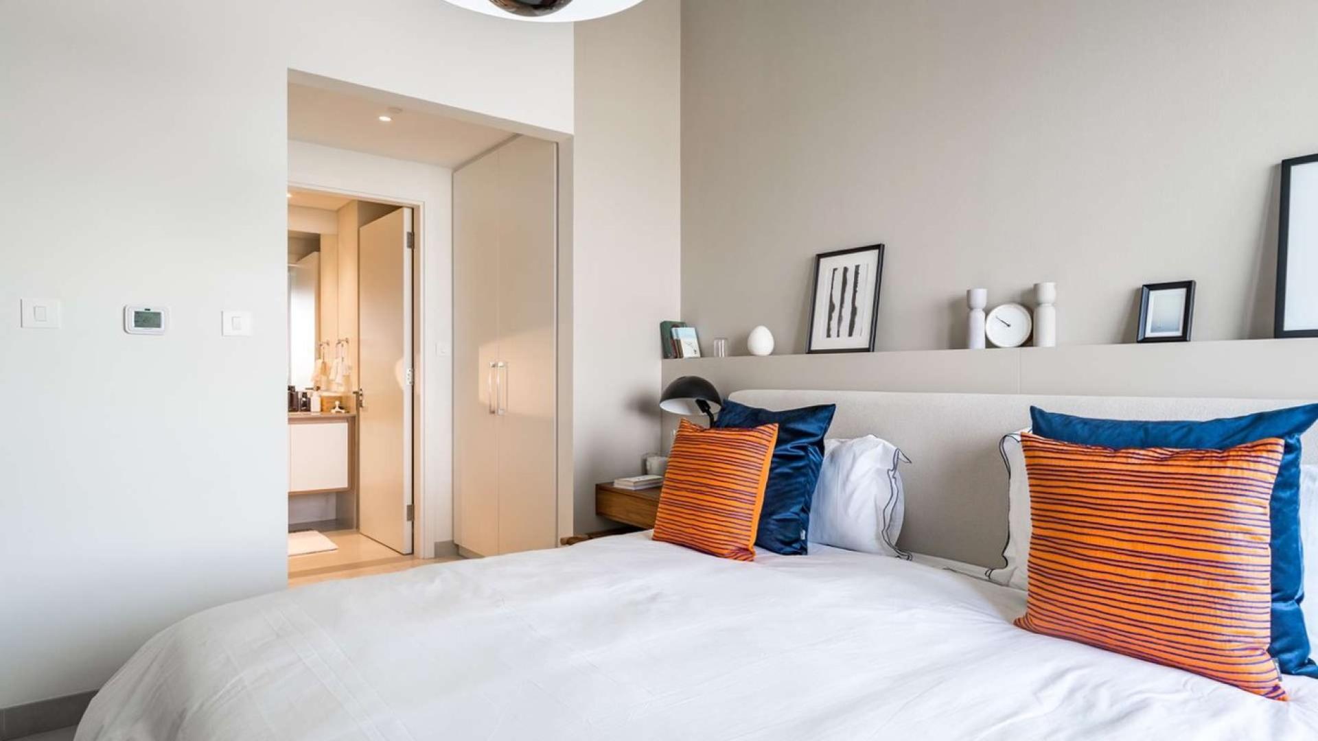 Modern kitchen in four-bedroom Emaar South apartment, Dubai South, featuring sleek appliances and decor