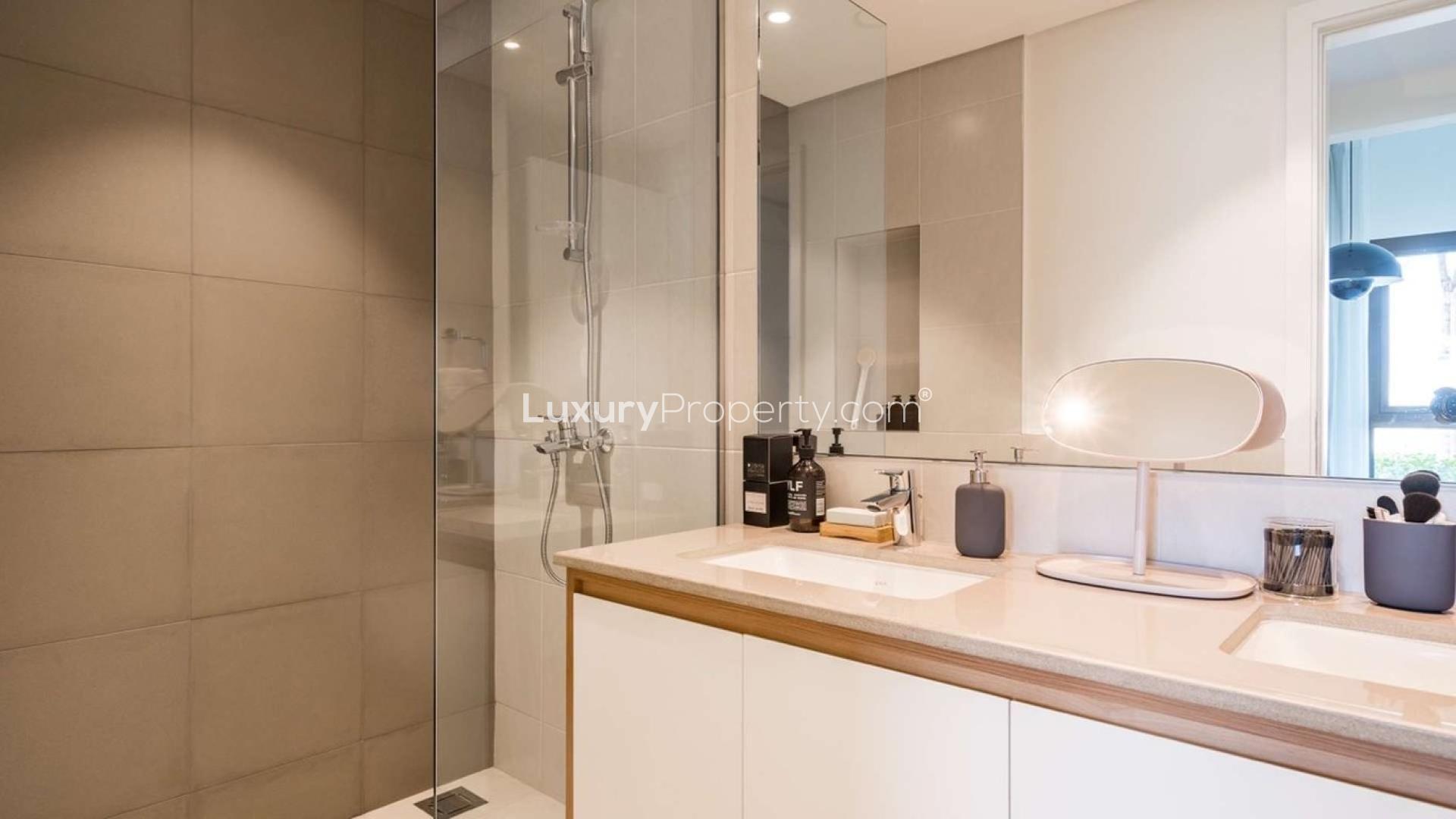 Modern living room in three-bed apartment, Golf Views, Dubai South, featuring elegant decor