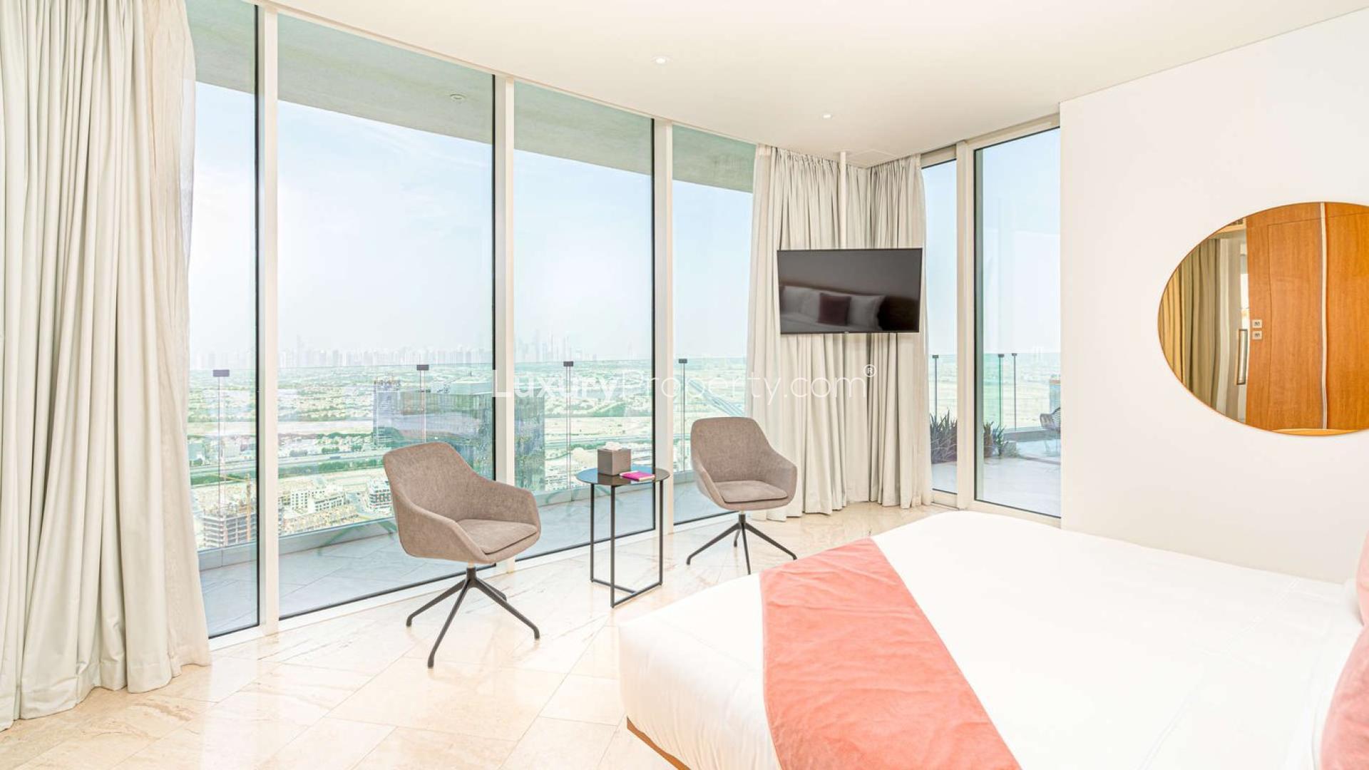 Modern living room in 2-bedroom apartment at FIVE Jumeirah Village, elegant decor, open layout