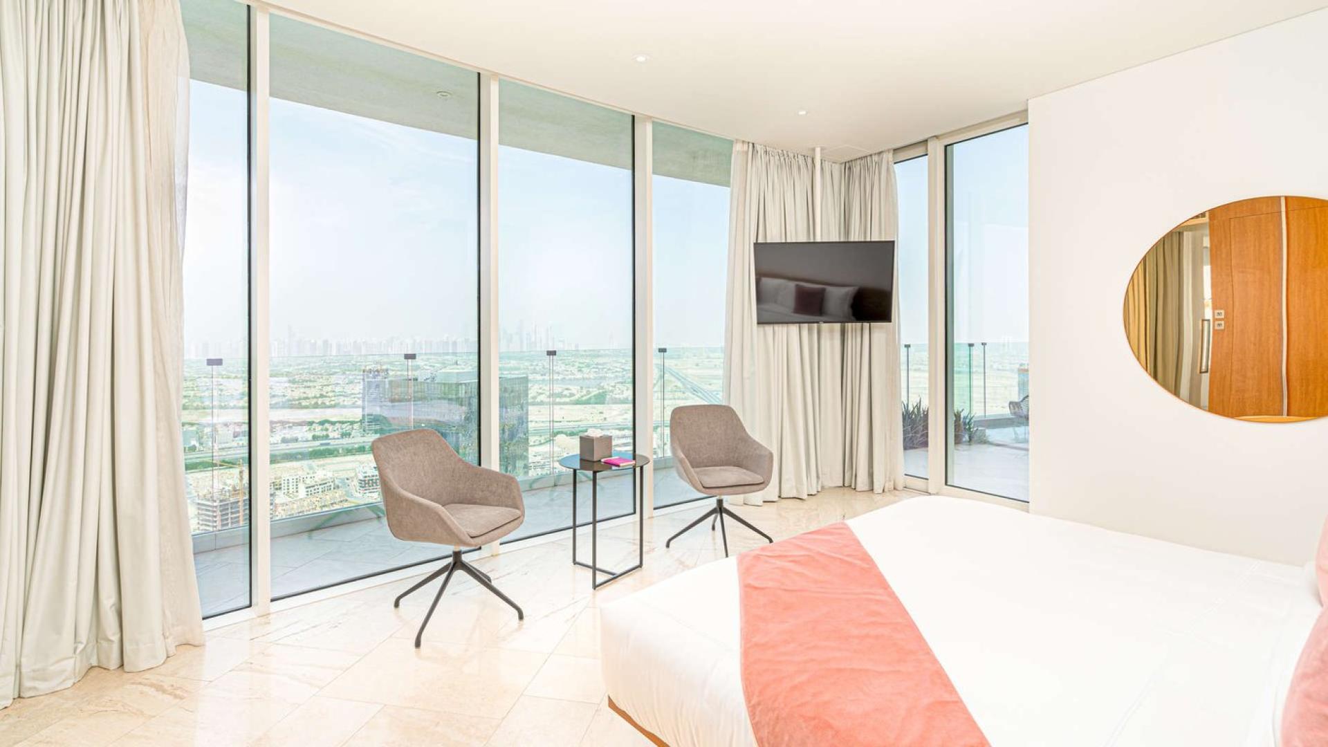 Modern living room in 2-bedroom apartment at FIVE Jumeirah Village, elegant decor, open layout