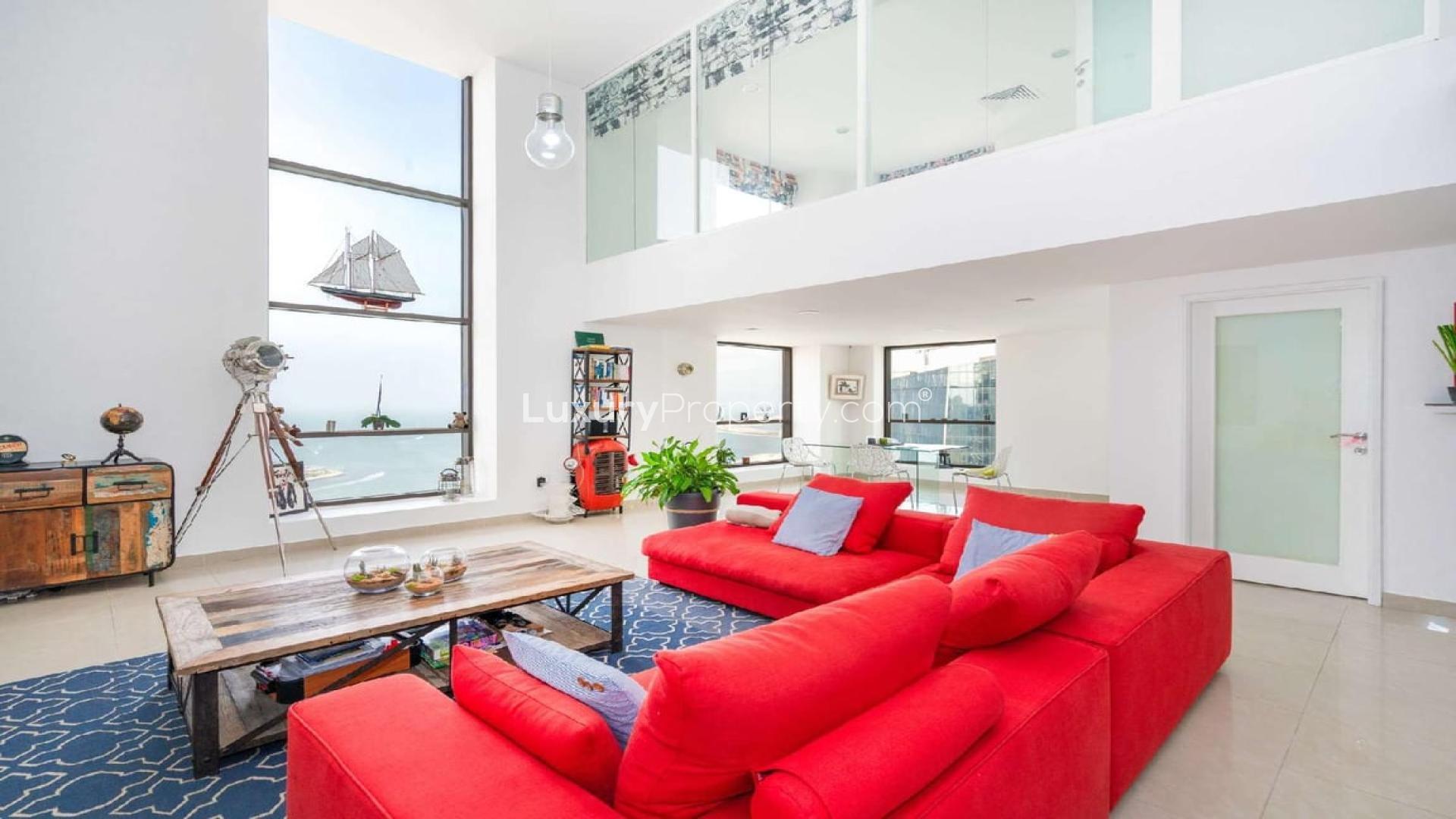 Modern loft apartment living room with red sofa and large windows, Bahar 5, JBR