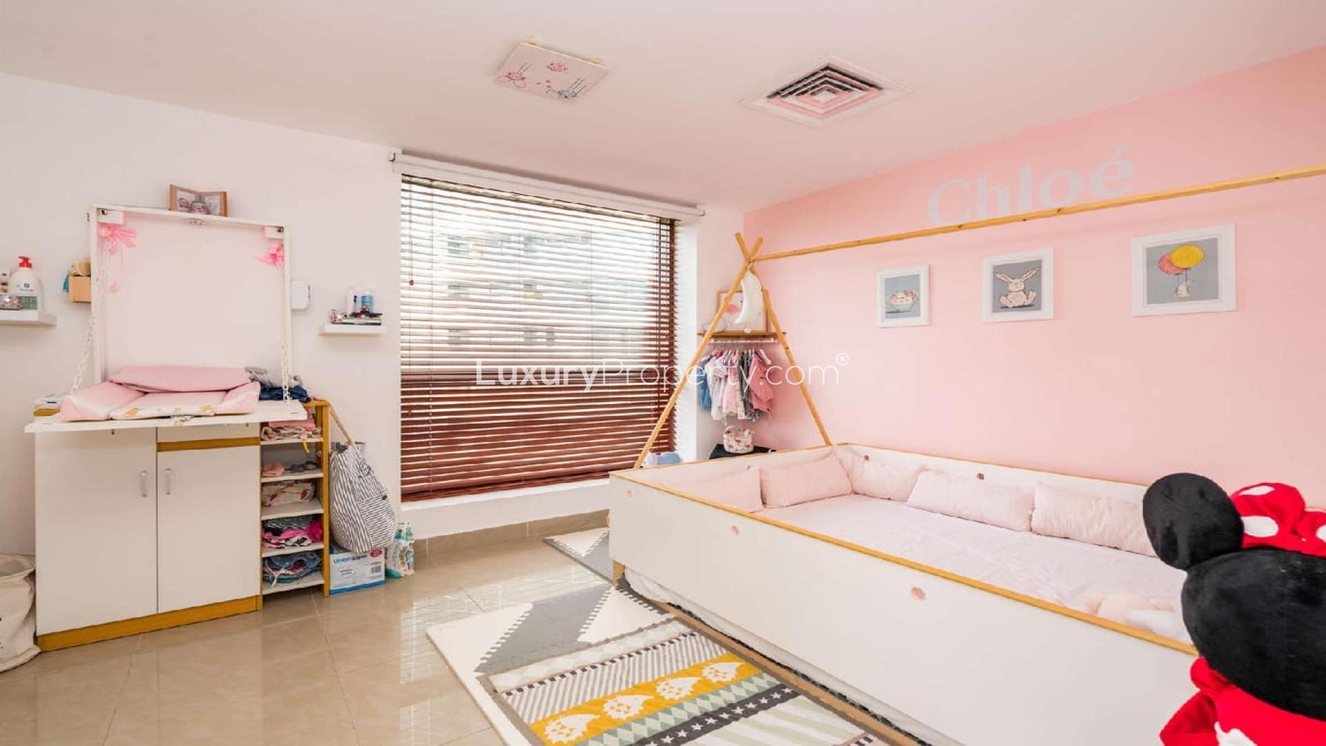 Red sofa in modern loft apartment, Bahar 5, JBR, with stylish decor and open staircase