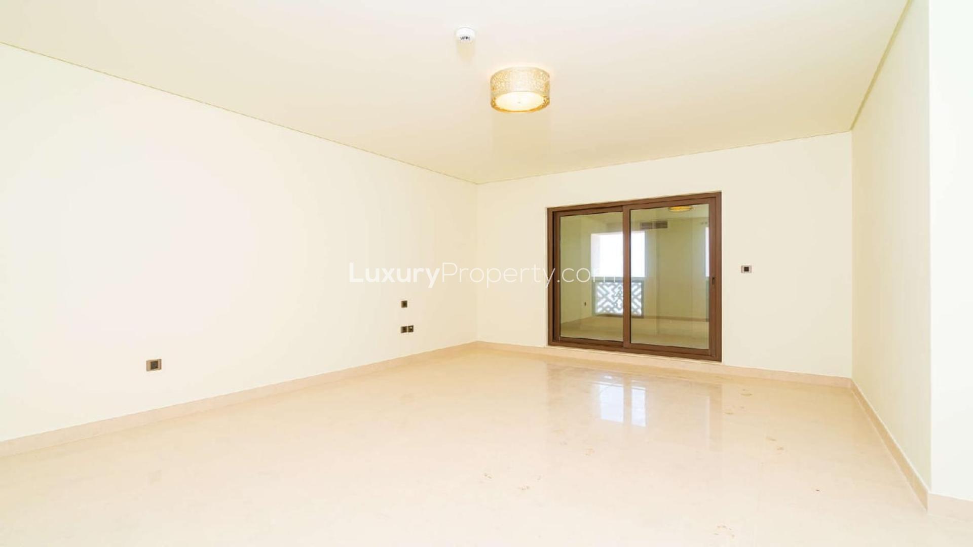Empty living room with large windows in Palm Jumeirah beachfront apartment, Kingdom of Sheba
