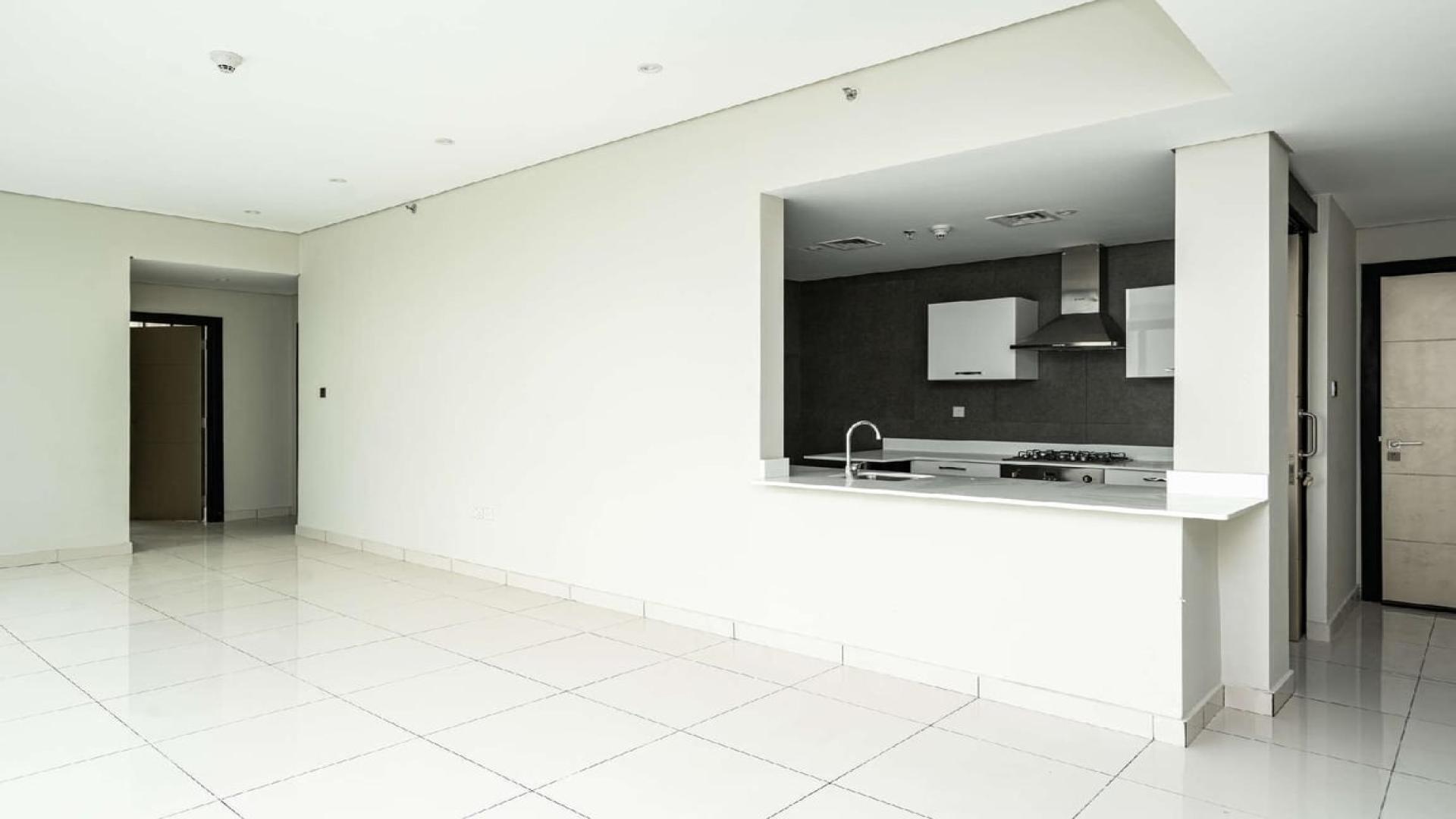 Modern kitchen in two-bedroom Meydan Avenue apartment for sale, featuring sleek white cabinetry