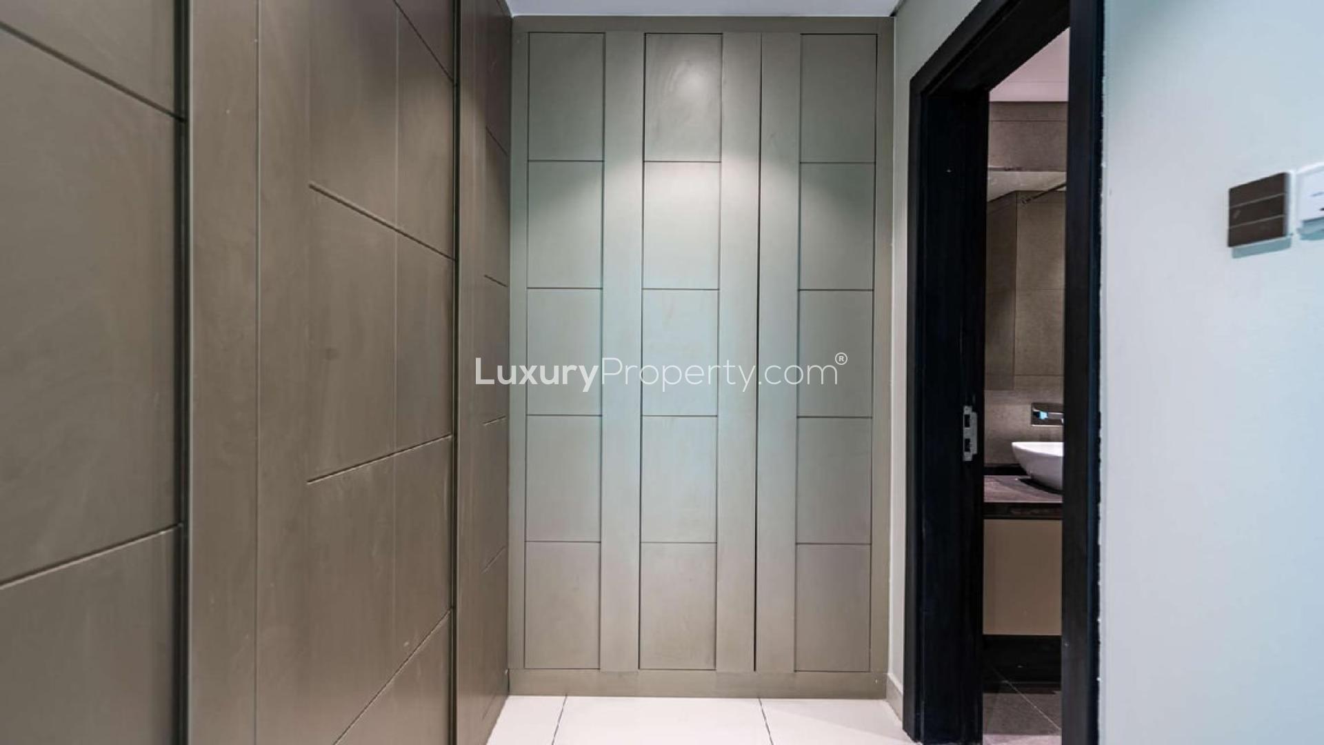 "Spacious living room with large windows in Meydan Avenue apartment for sale.",Cosy two-bedroom apartment entrance in Meydan Avenue, featuring sleek modern design and finishes