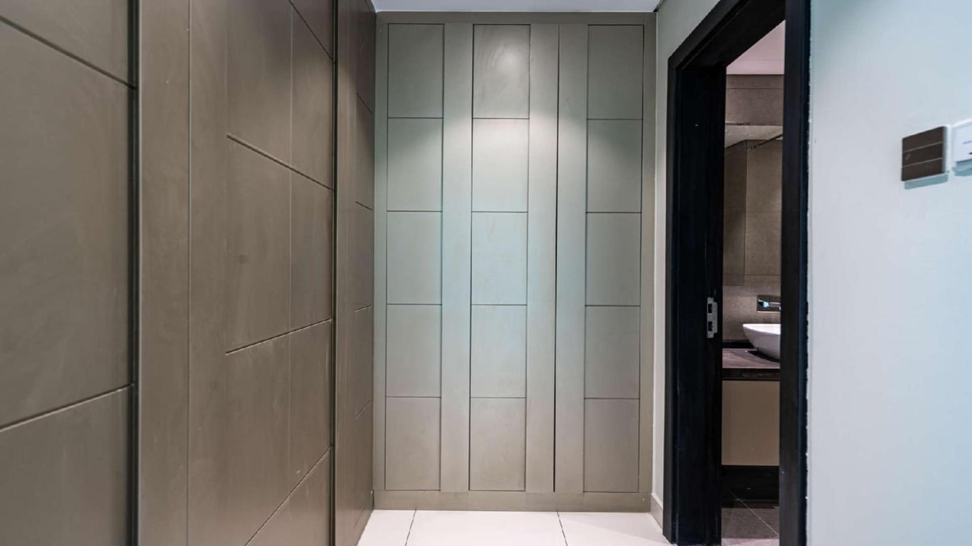 "Spacious living room with large windows in Meydan Avenue apartment for sale.",Cosy two-bedroom apartment entrance in Meydan Avenue, featuring sleek modern design and finishes