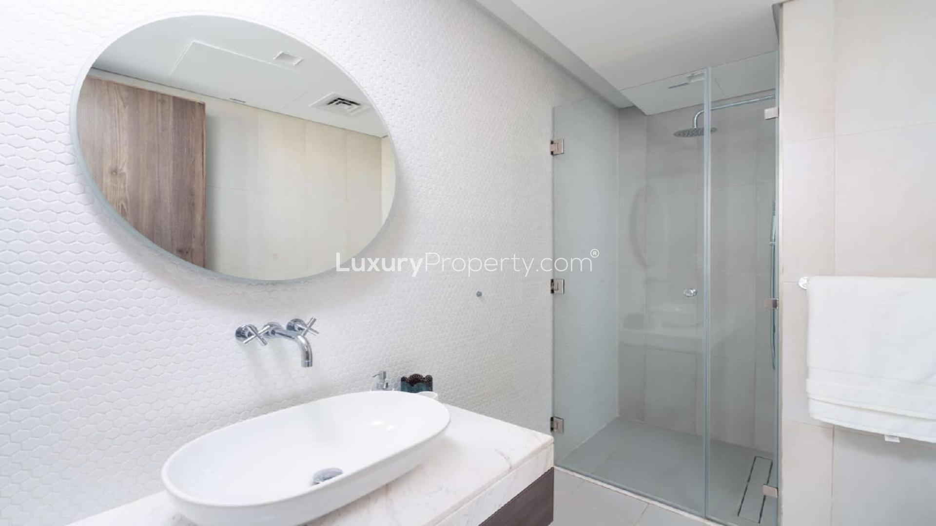 "View from Soho Palm Jumeirah apartment balcony overlooking cityscape and sea, LP03879 for sale.",Modern bathroom with glass shower in Soho Palm Jumeirah apartment for sale