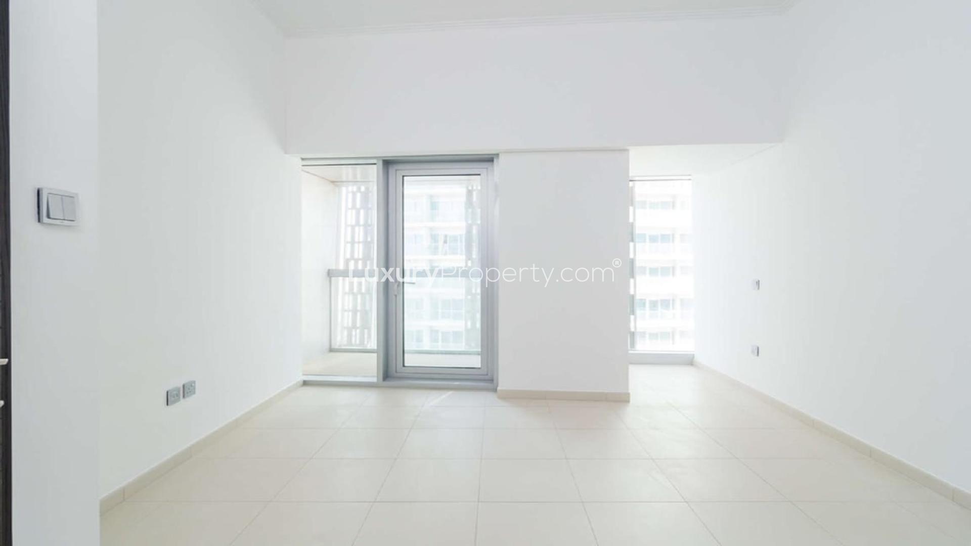 Modern kitchen with purple cabinets in Cayan Tower apartment, Dubai Marina