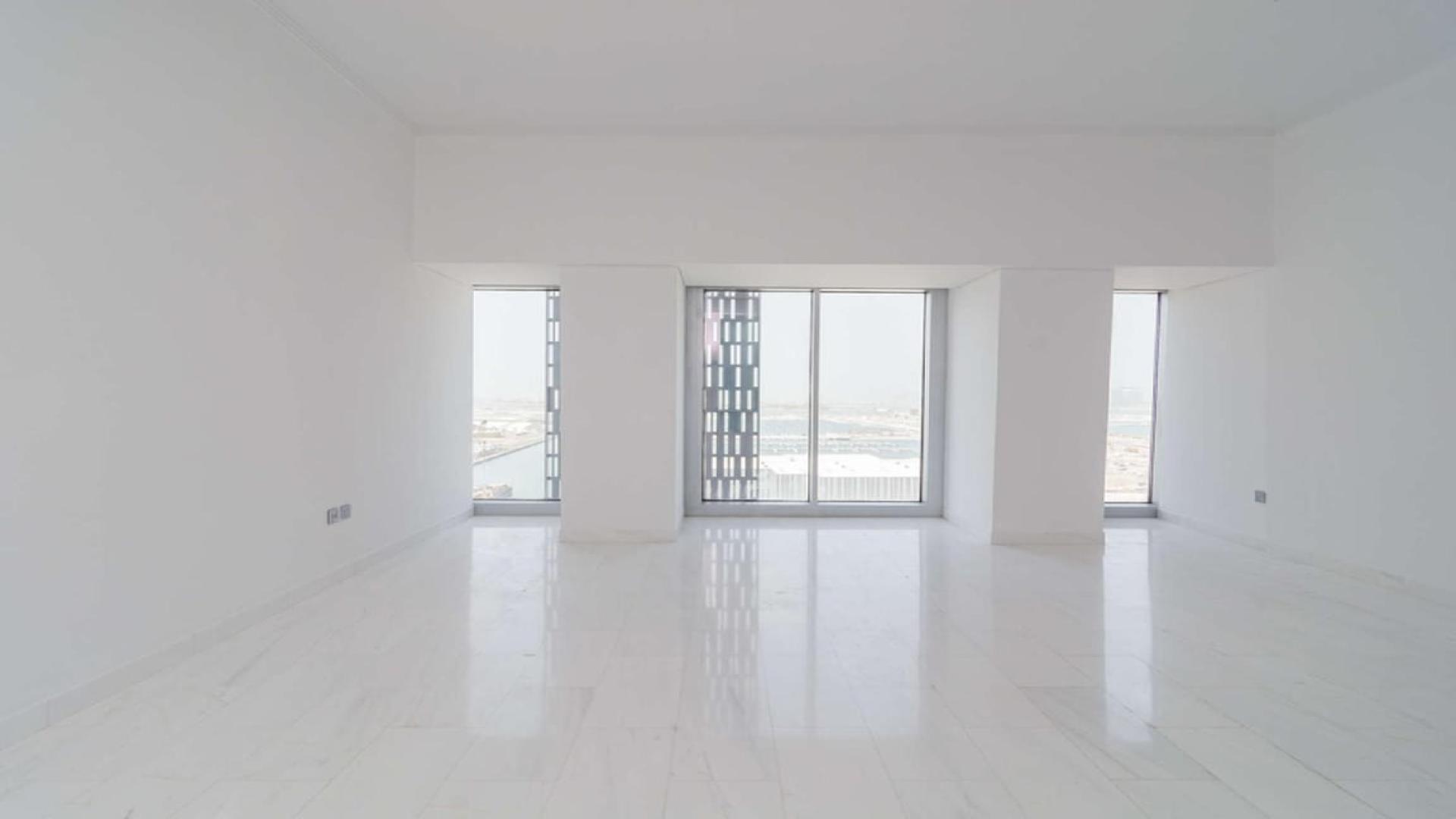 Spacious, bright apartment interior with large windows in Cayan Tower, Dubai Marina