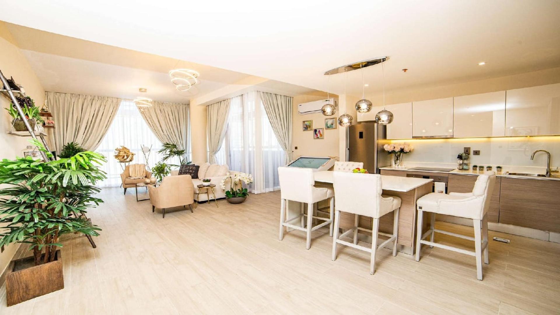 Modern open-plan living and dining area in Q Gardens 2-bedroom apartment, Arjan