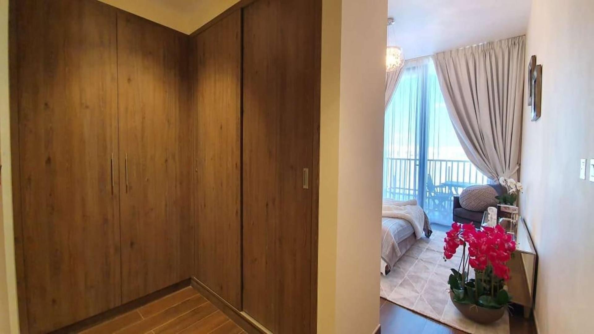 Modern open-plan living area in Q Gardens 2-bedroom apartment, Arjan, with elegant decor