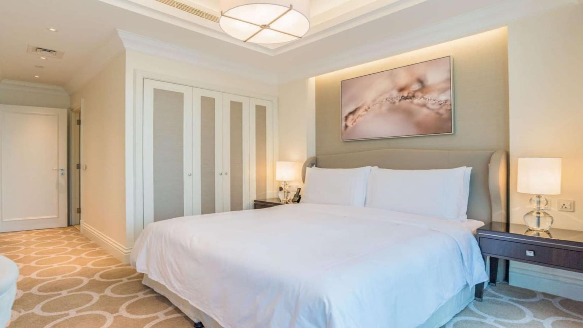 Luxurious living room in Downtown Dubai apartment, featuring elegant dining area and modern decor