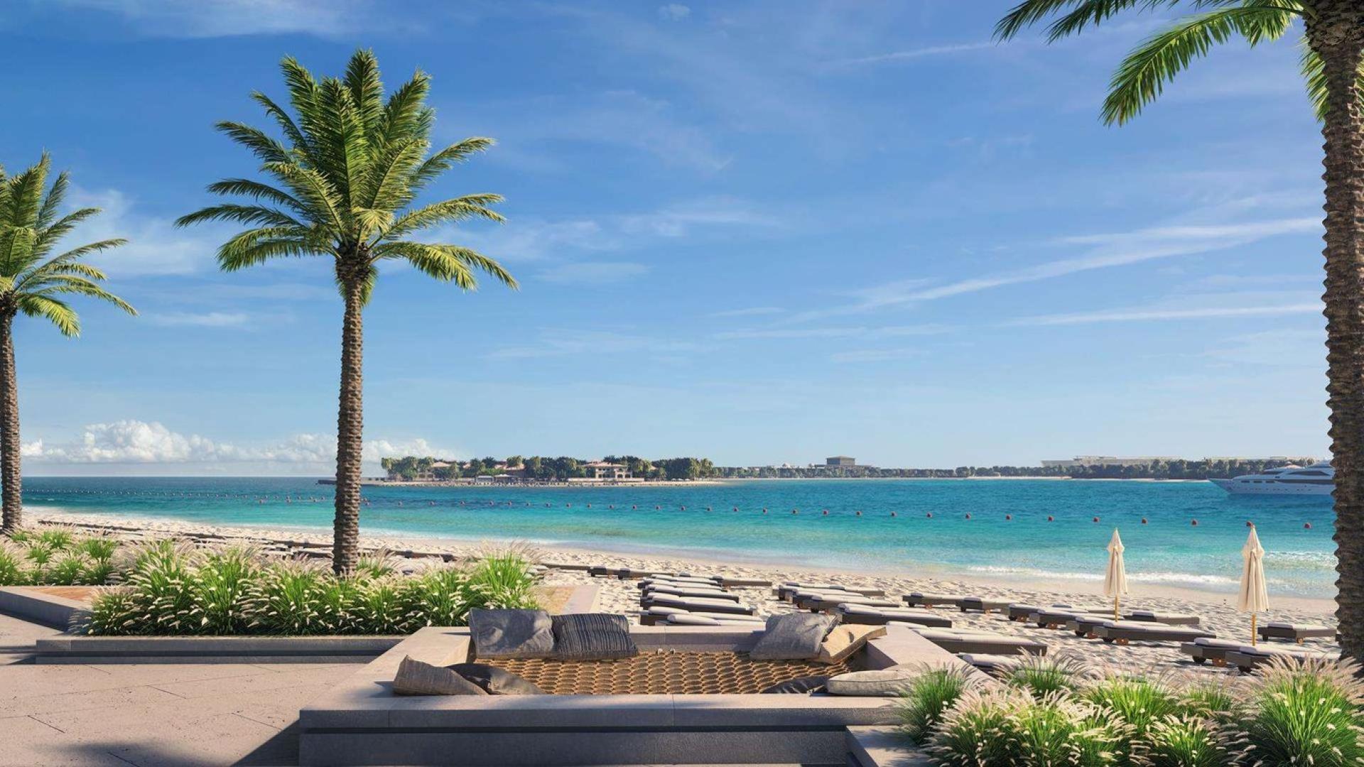 Modern open-plan kitchen and dining area in three-bedroom Emaar Beachfront apartment for sale