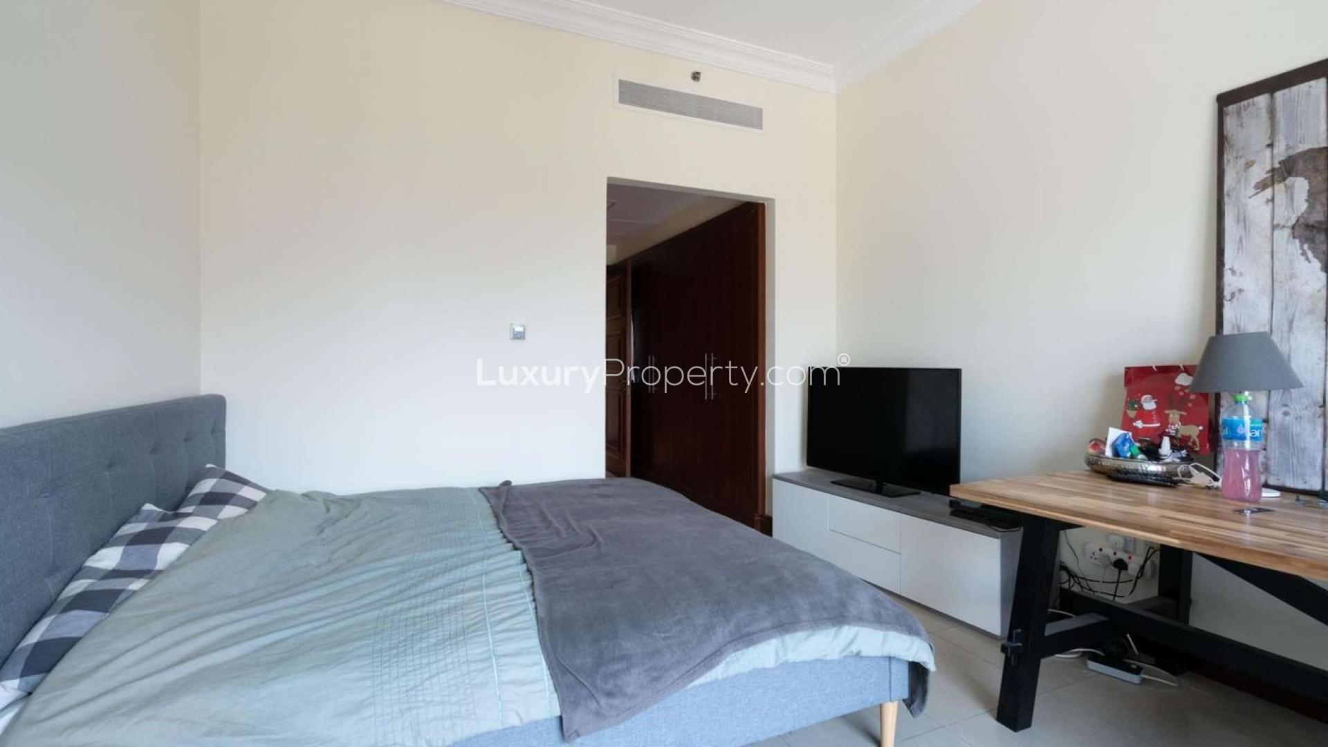 Bright bedroom in 2-bedroom Palm Jumeirah apartment, featuring large windows and modern decor
