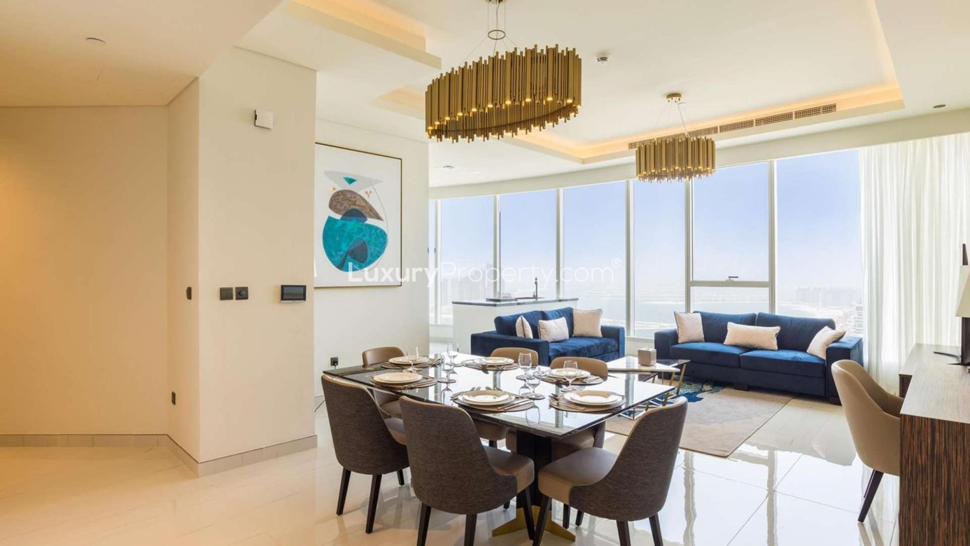 Fully furnished living room in Dubai Media City apartment, modern decor, open kitchen layout