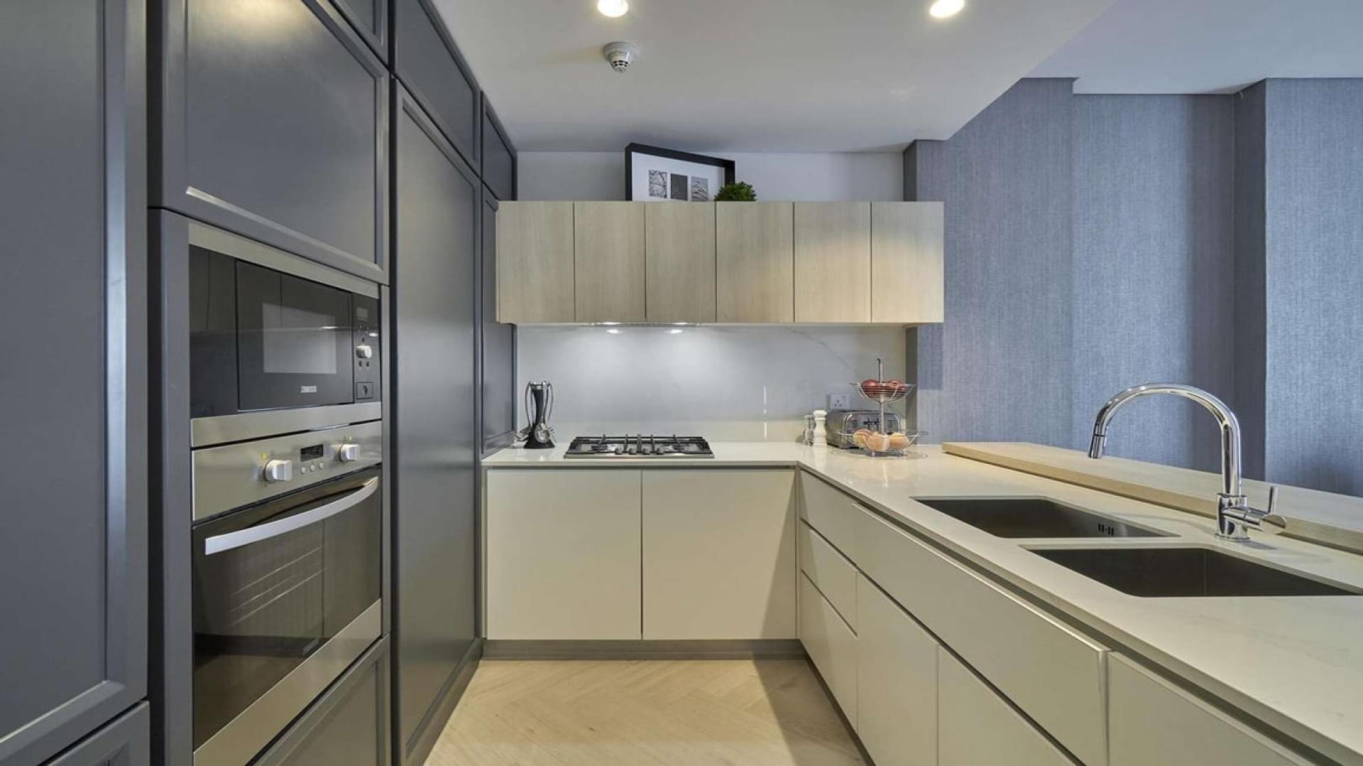 Modern kitchen in Wilton Terraces 1 apartment, Mohammed Bin Rashid City, featuring sleek cabinetry