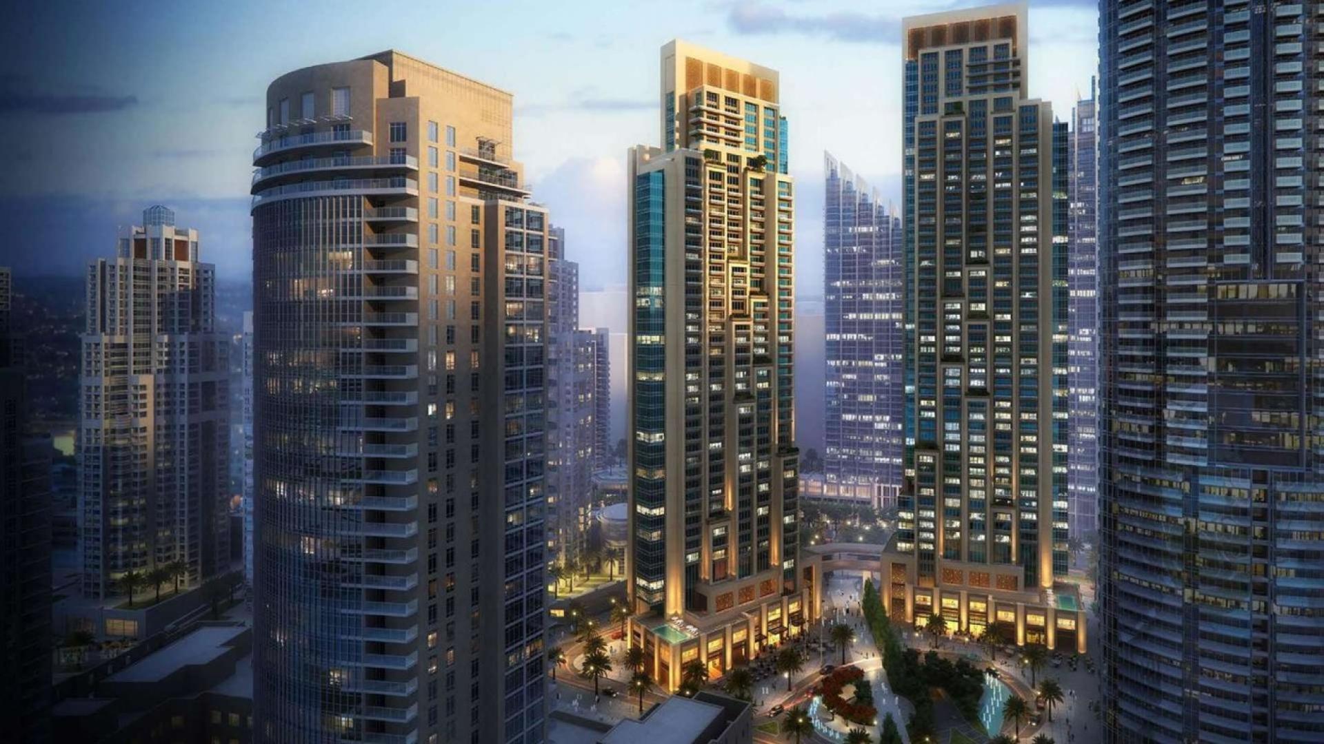 Luxurious living room in Downtown Dubai apartment with cityscape view, elegant decor, and dining area