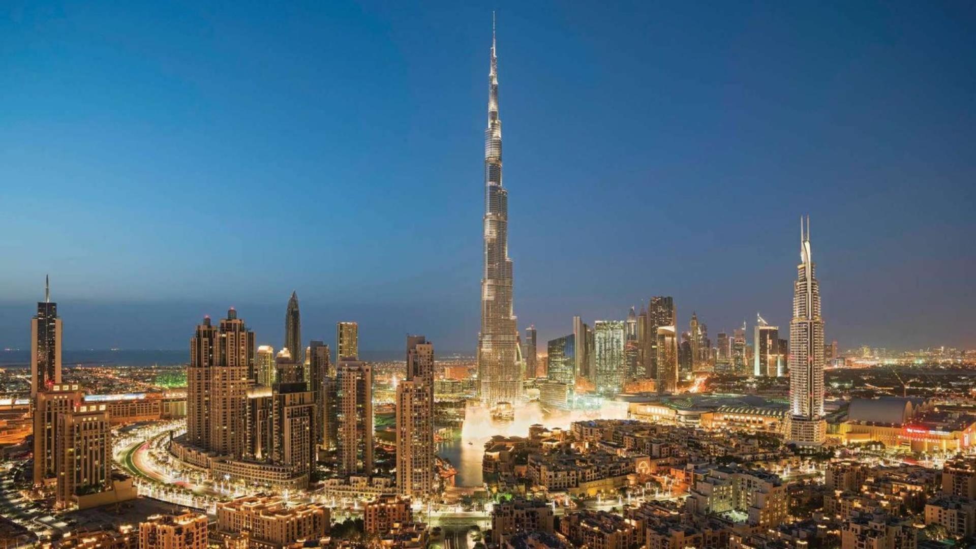Aerial view of Downtown Dubai skyline featuring Burj Khalifa and vibrant Opera District