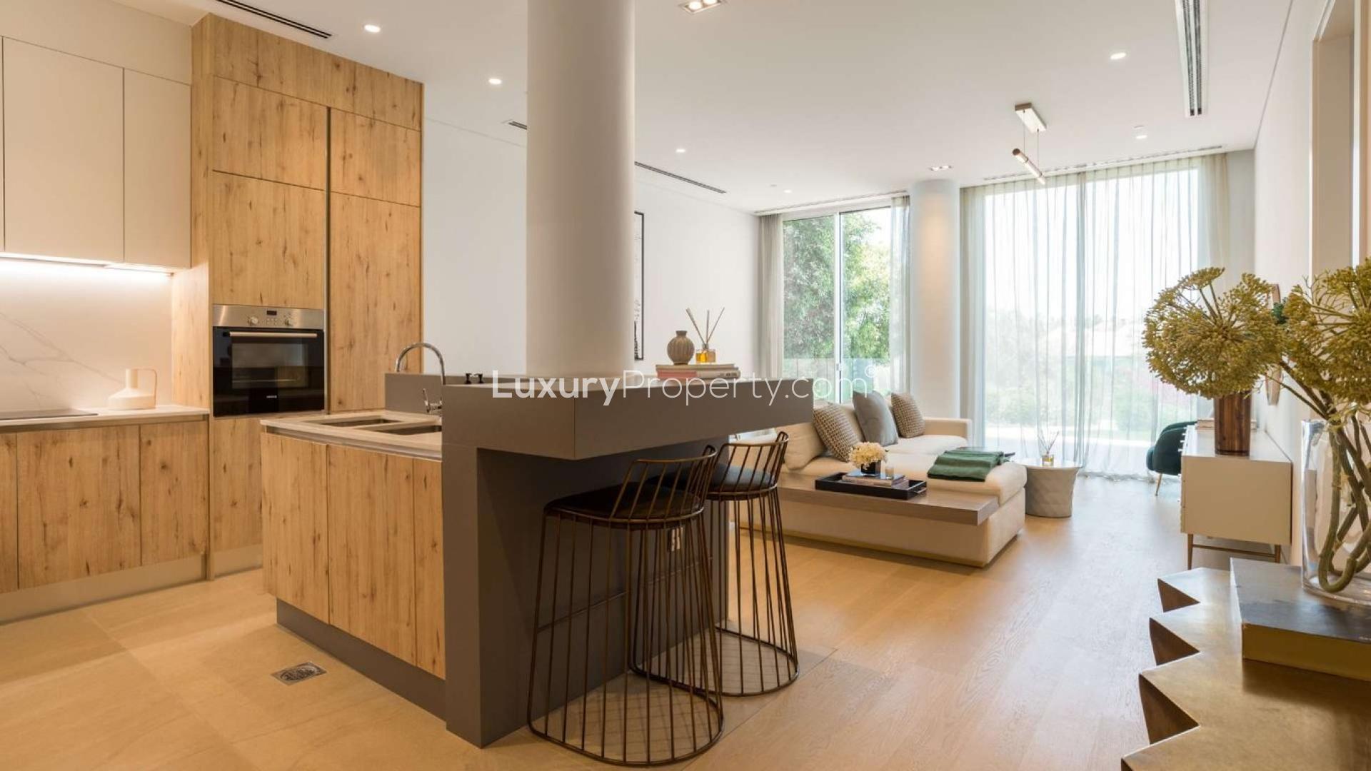 Luxurious living room in 2-bed duplex, Al Barari, featuring modern decor and large windows