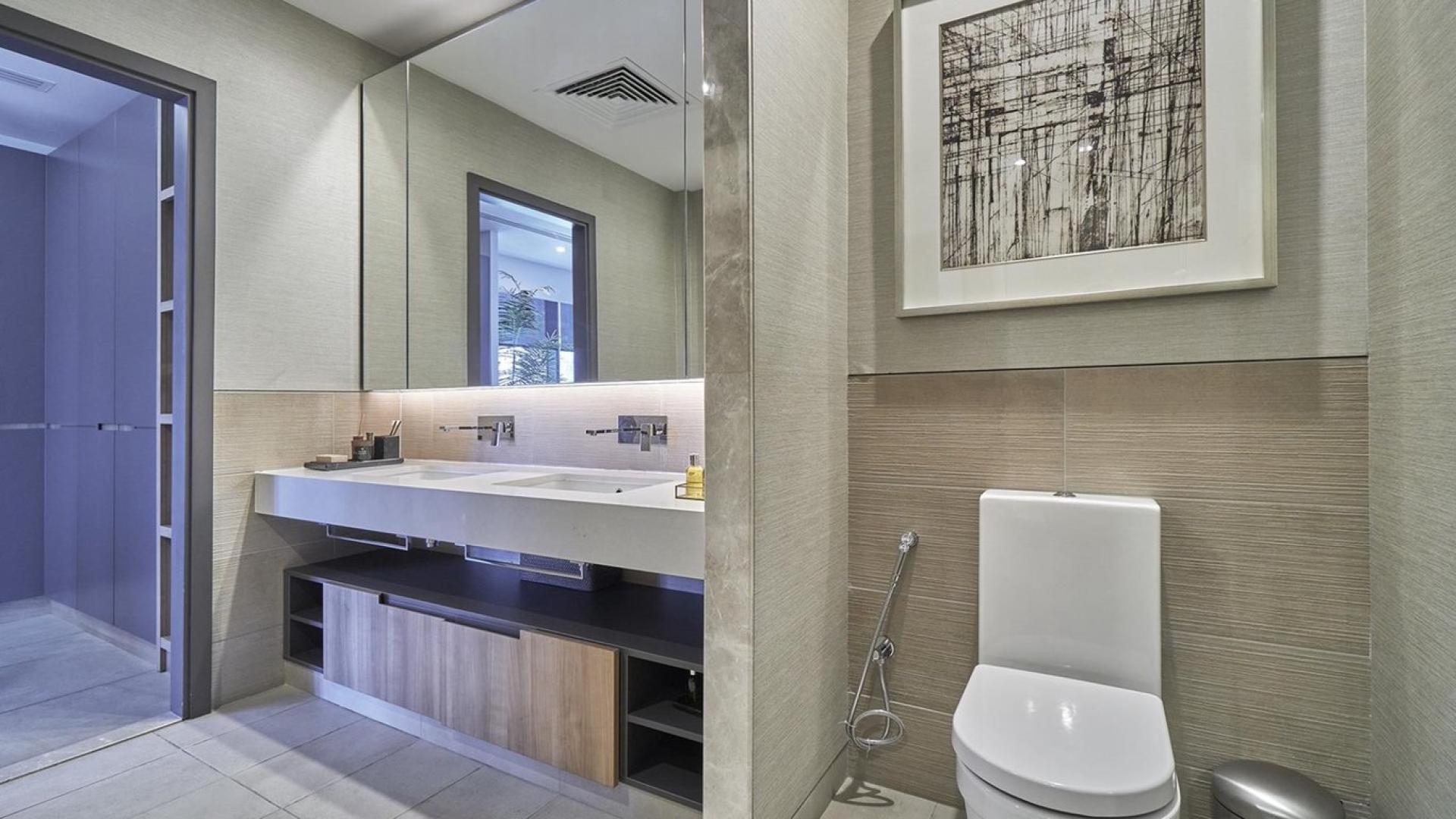 Modern bathroom in high-floor Downtown Dubai apartment, featuring sleek fixtures and elegant design