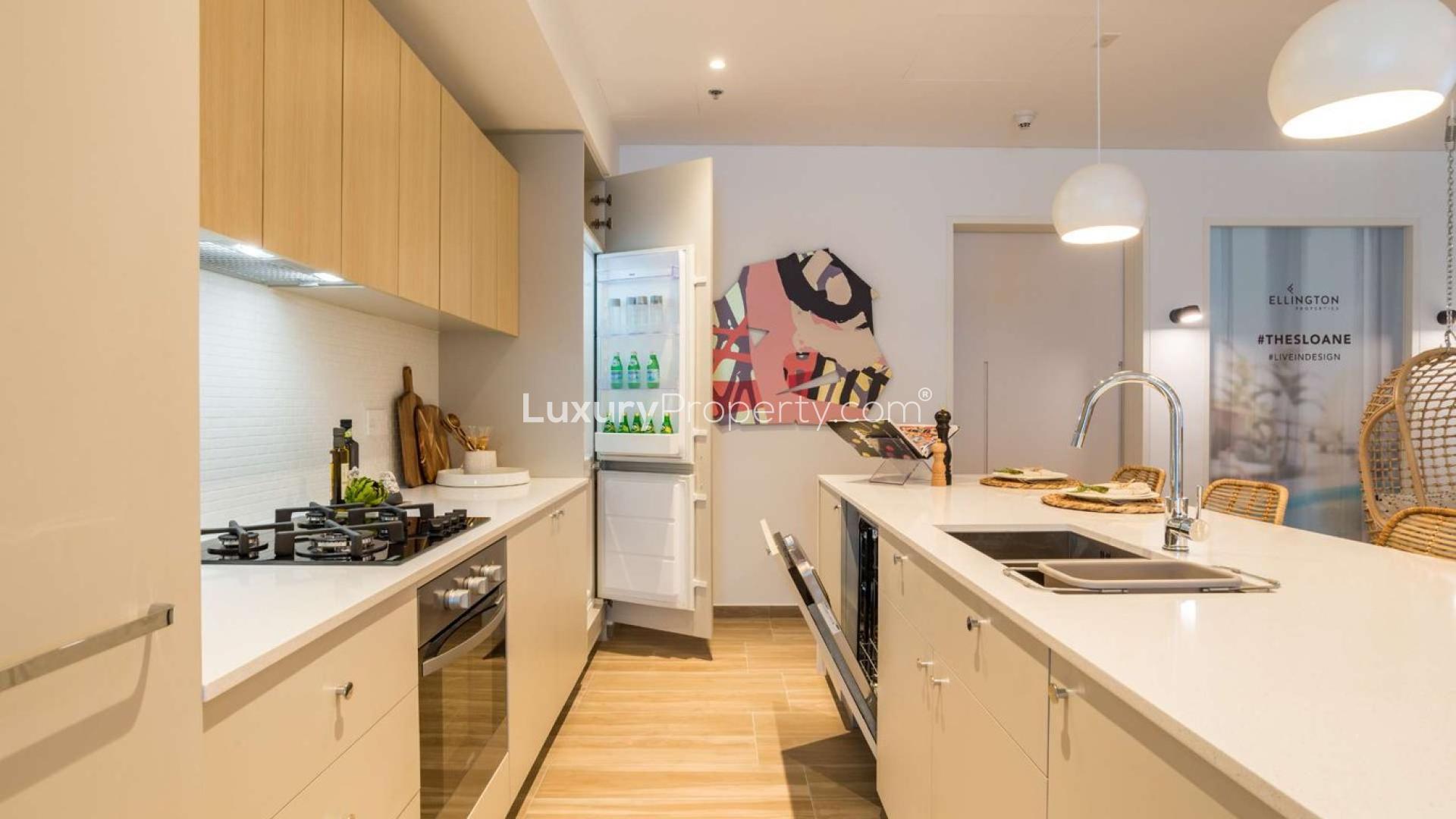 Modern kitchen in JVC apartment, featuring sleek countertops and open fridge, The Sloane