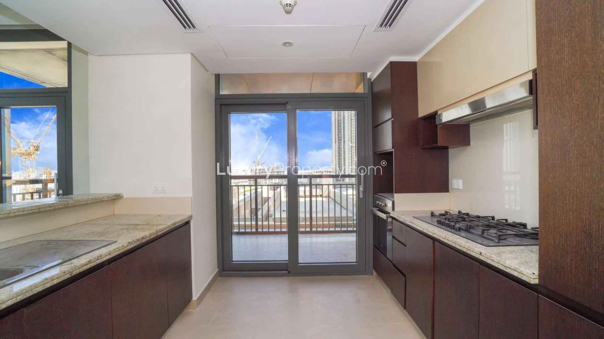 "Bright living area with large windows in Dubai Creek Residence Tower 3 North apartment.",Modern kitchen in 2-bedroom apartment, Dubai Creek Residence Tower 3 North, Dubai Creek Harbour
