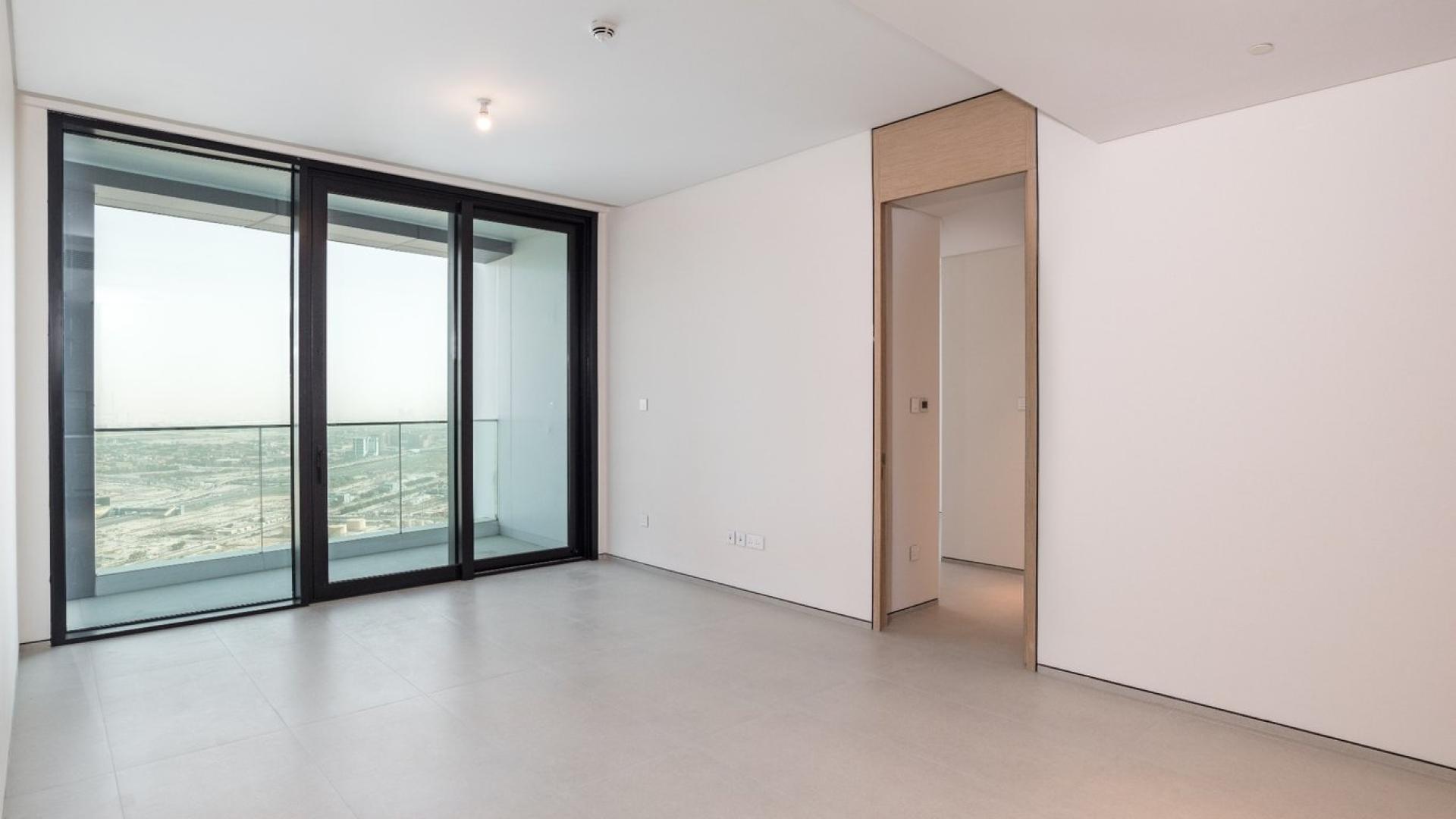 Empty living room with large windows, balcony view, Address Jumeirah apartment for sale