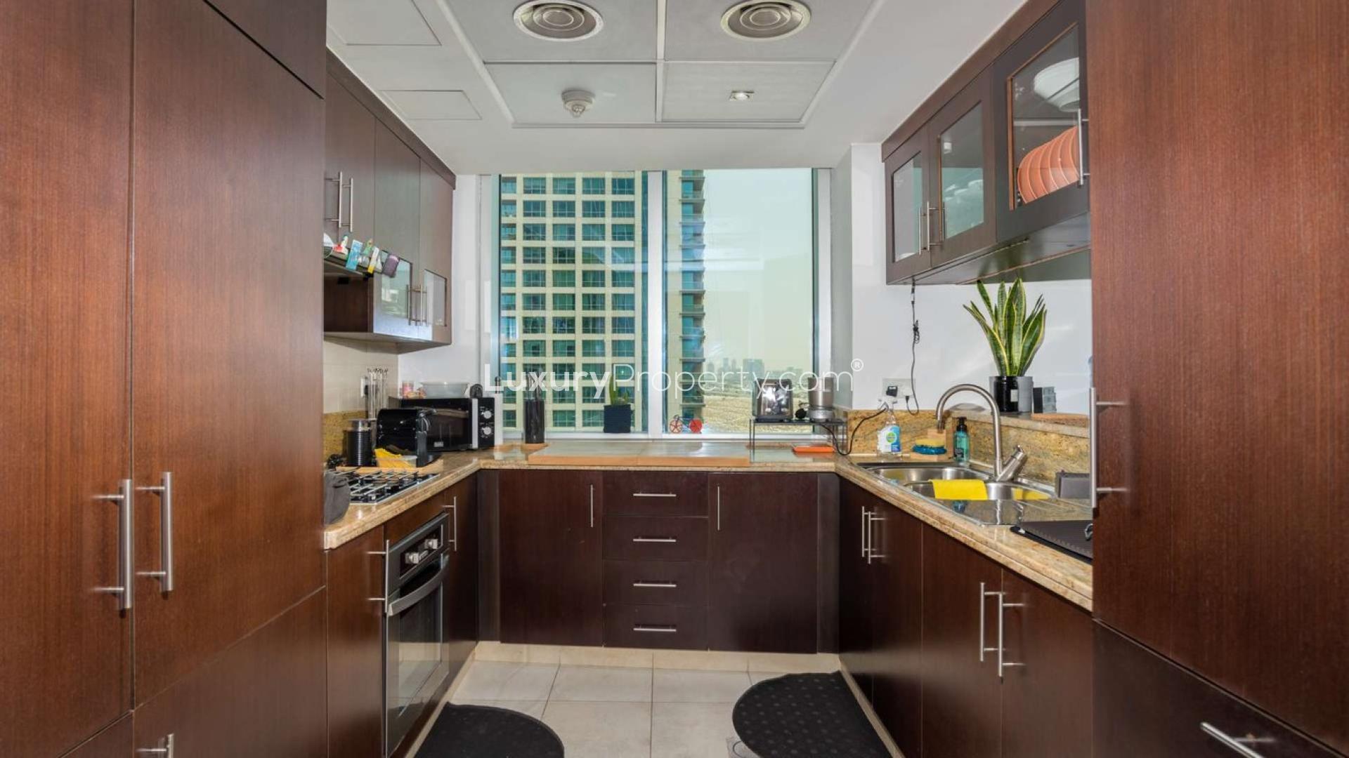 Bright living room in The Fairways apartment with panoramic city views, The Views community