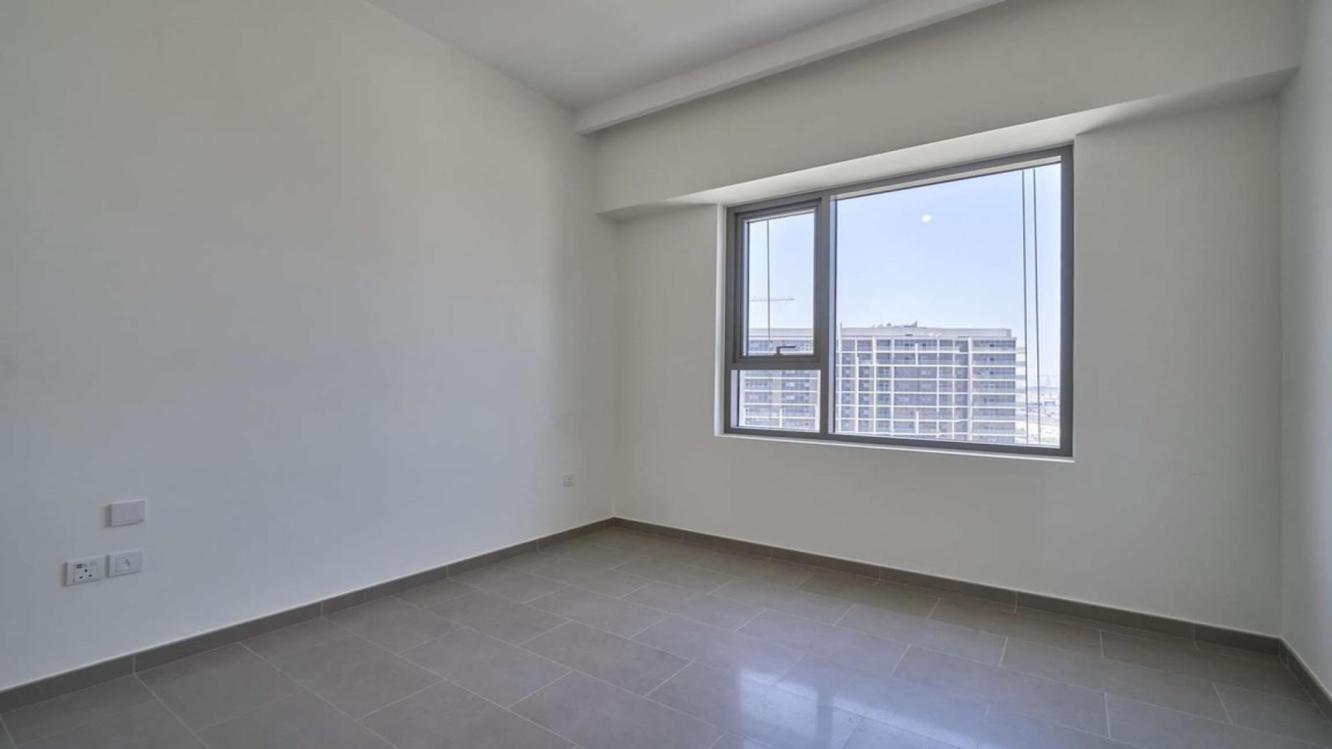 Empty apartment room with large window, balcony view, Dubai Hills Estate, Park Heights