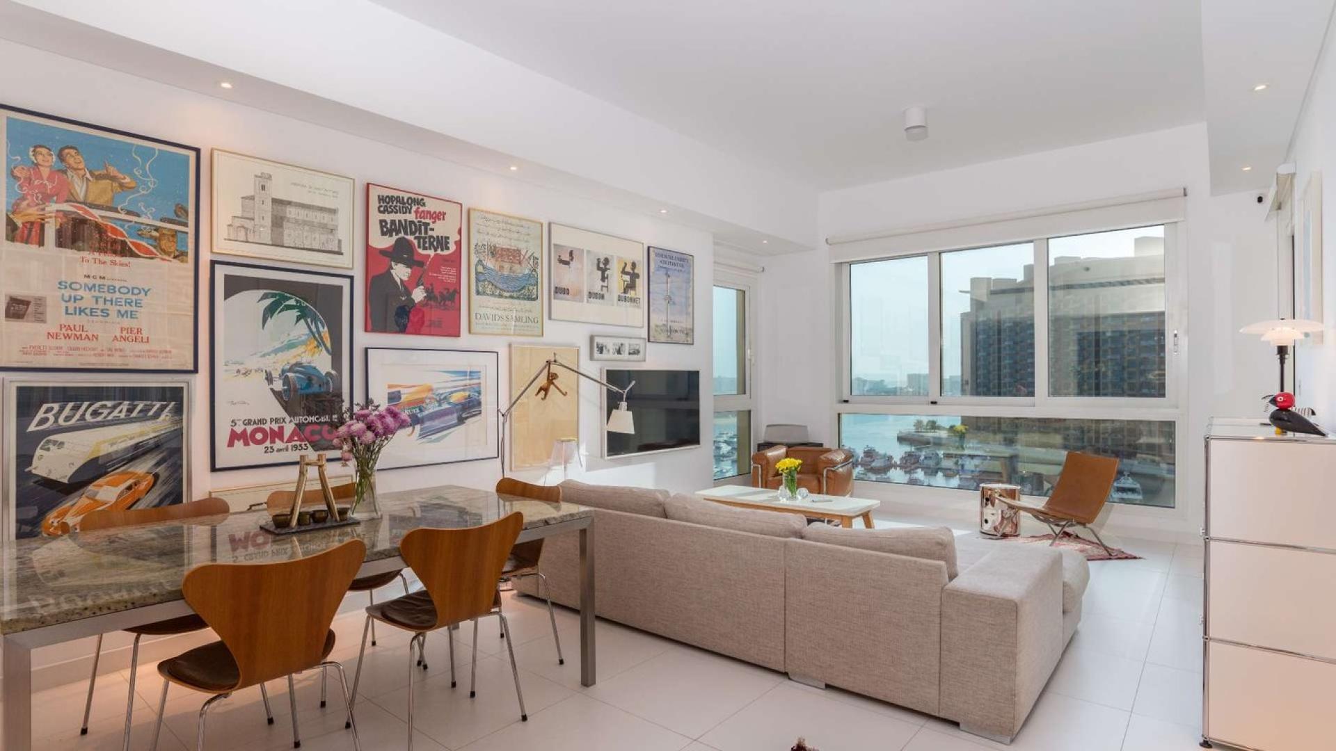 Contemporary living room in Palm Jumeirah apartment with marina view through large windows