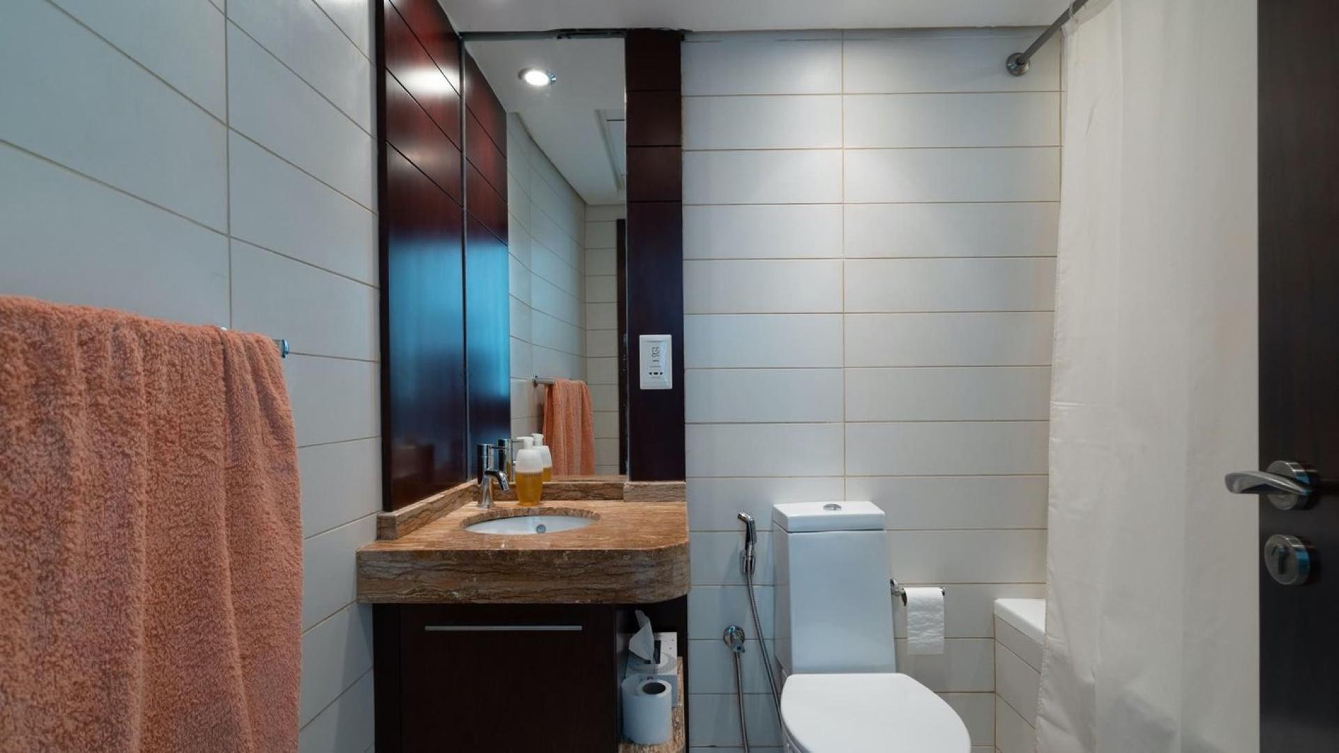 Empty living room with tiled floors in Burj Views apartment, Downtown Dubai