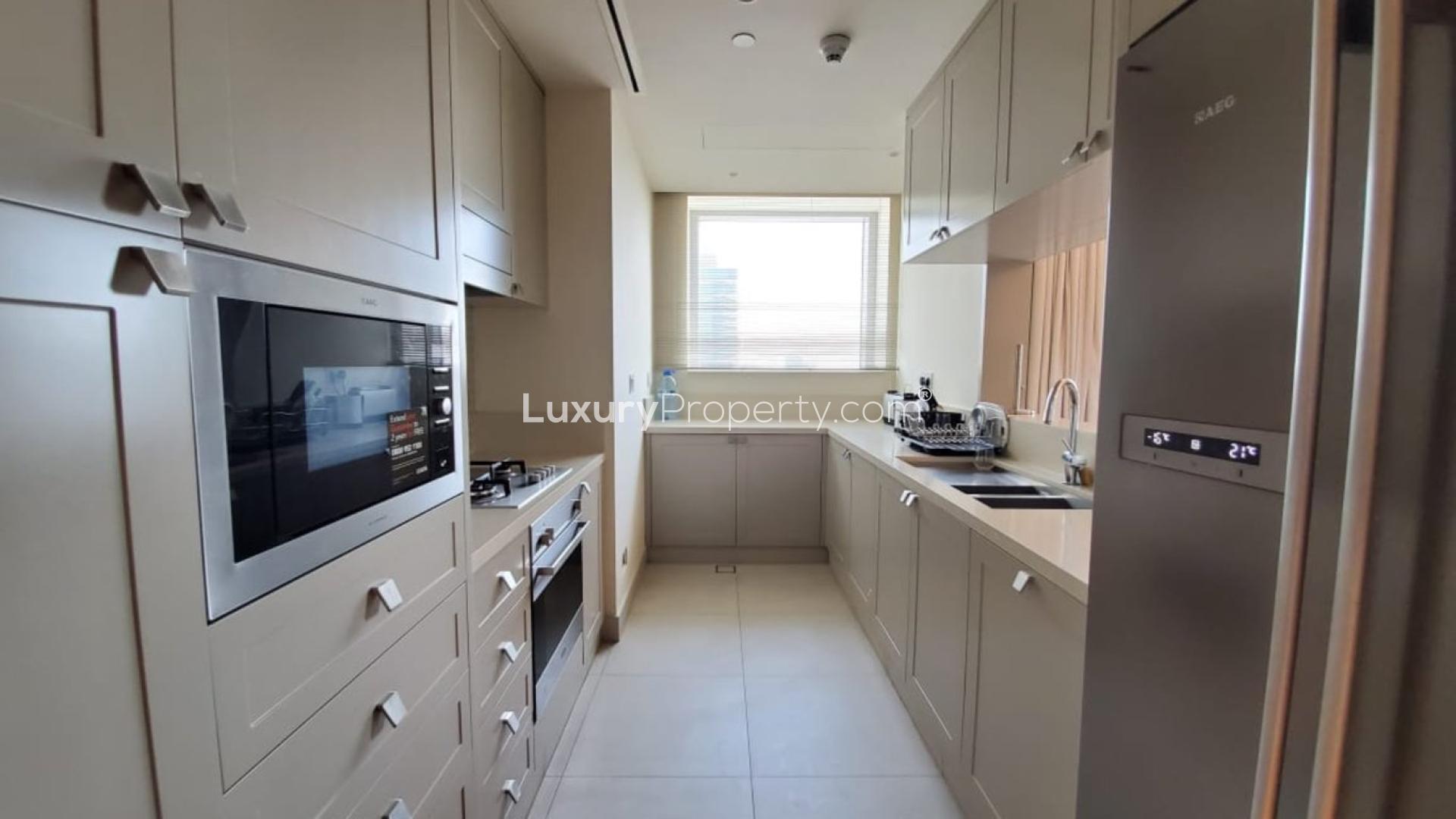 Spacious living room in Downtown Dubai apartment with modern decor and open dining area