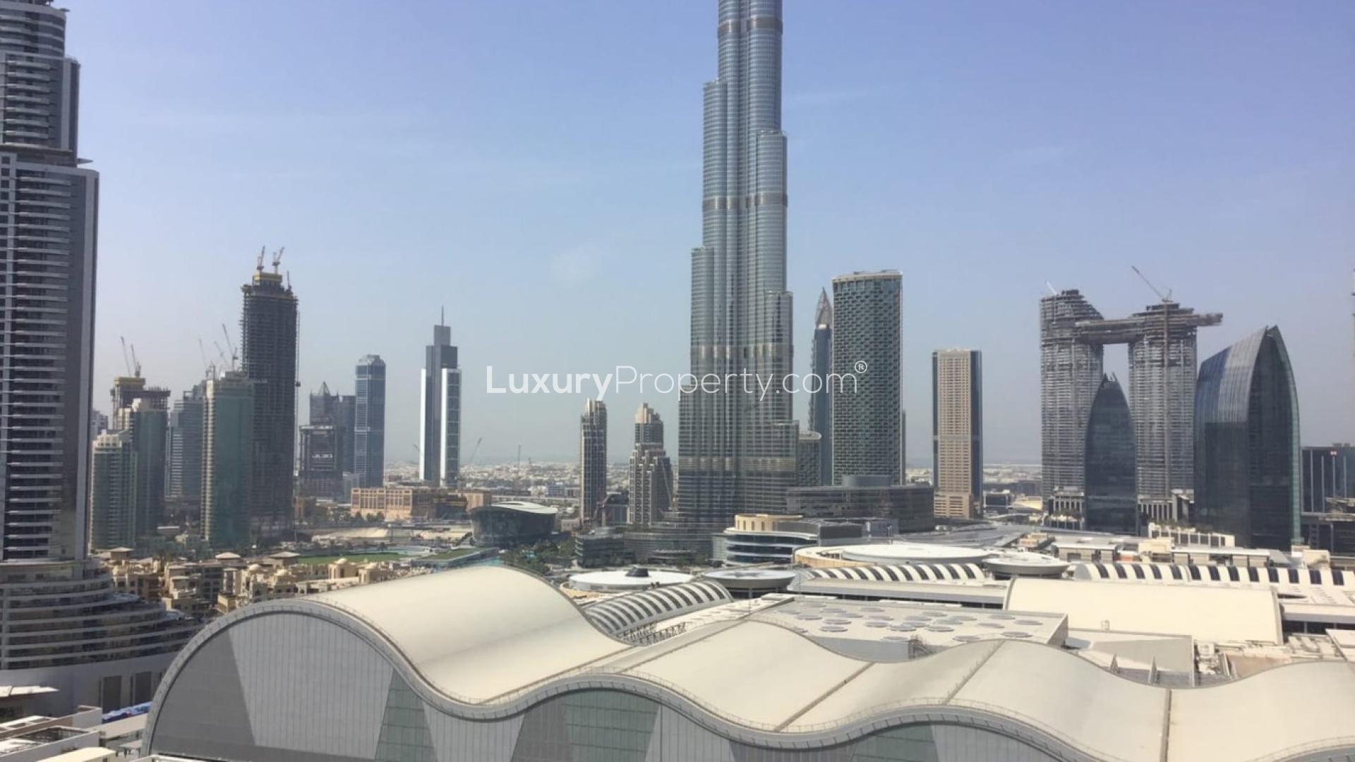 Furnished living and dining area in Downtown Dubai apartment with marble flooring and elegant decor