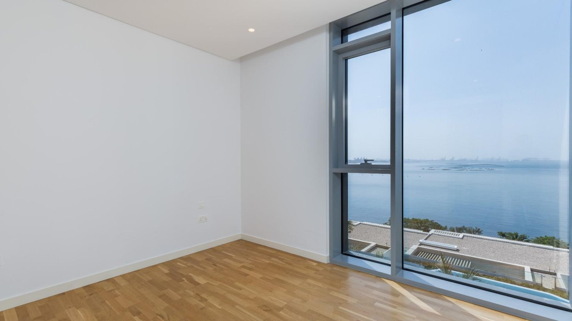 Spacious Bluewaters apartment with ocean view, hardwood floors, and floor-to-ceiling windows