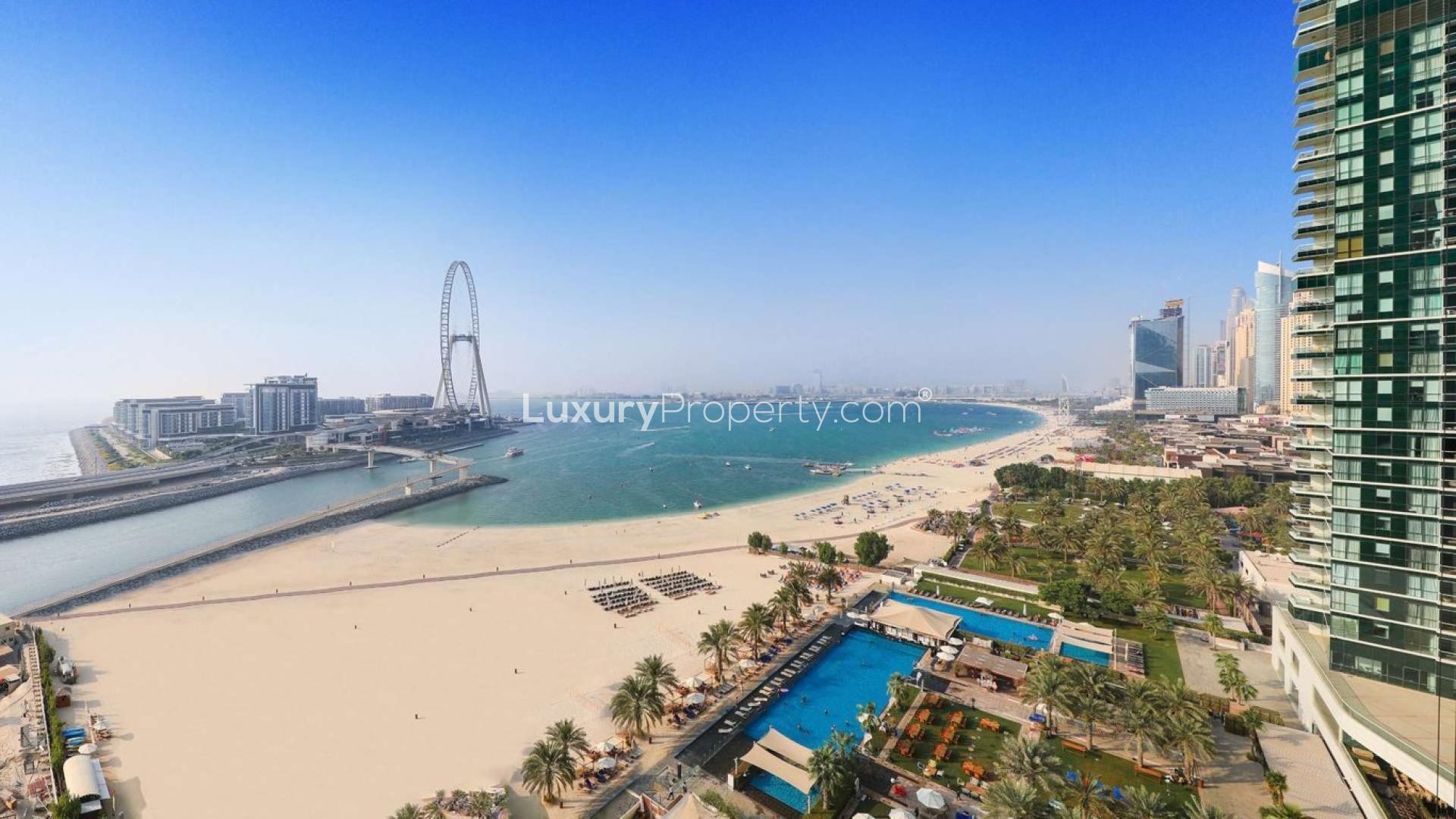 "Beachfront apartment interior with ocean view, Jumeirah Beach Residence, for sale.",Empty room with large windows showcasing beach and ocean view at Jumeirah Beach Residence