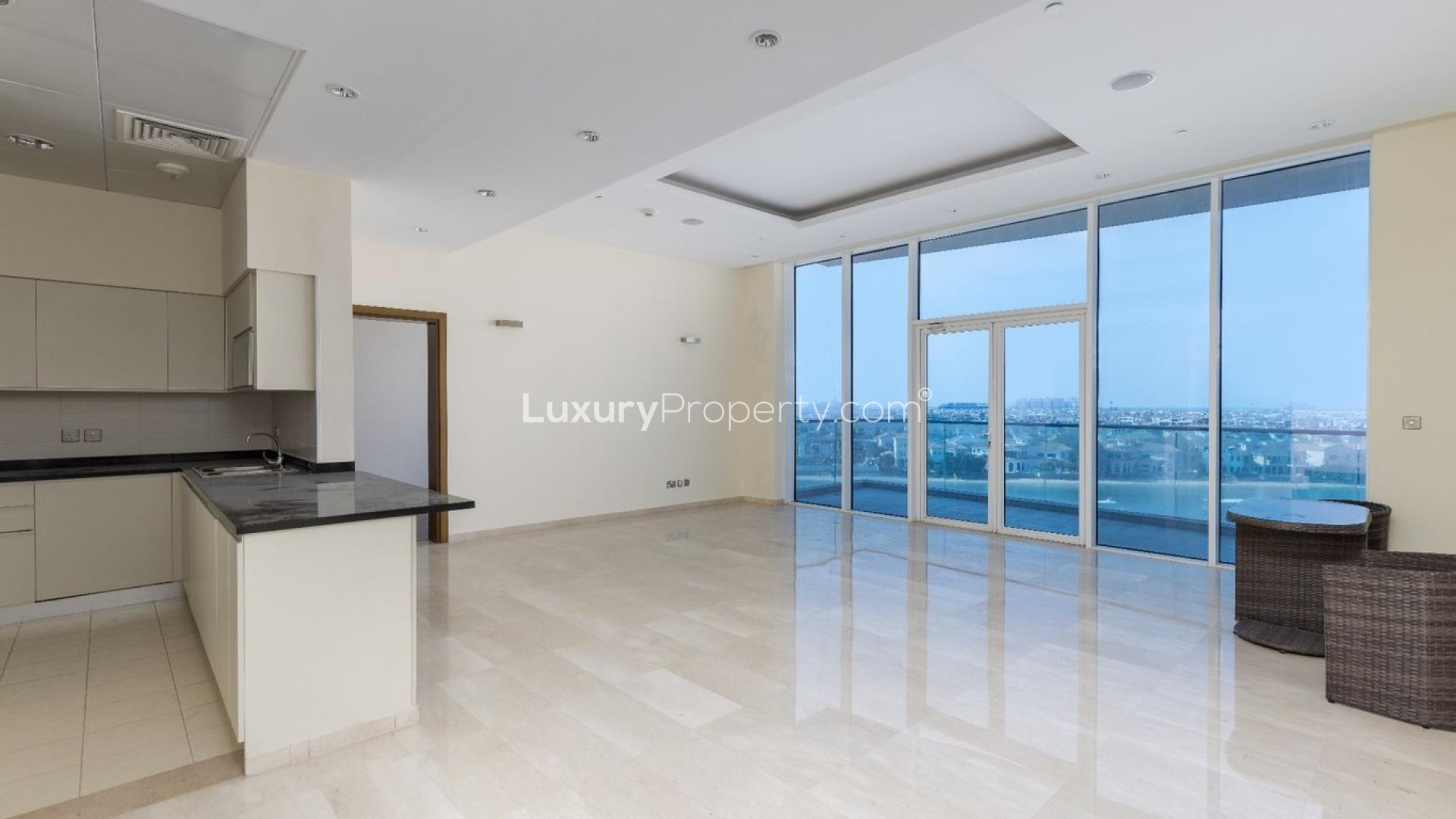 Spacious living area with large windows and stunning views in Palm Jumeirah apartment