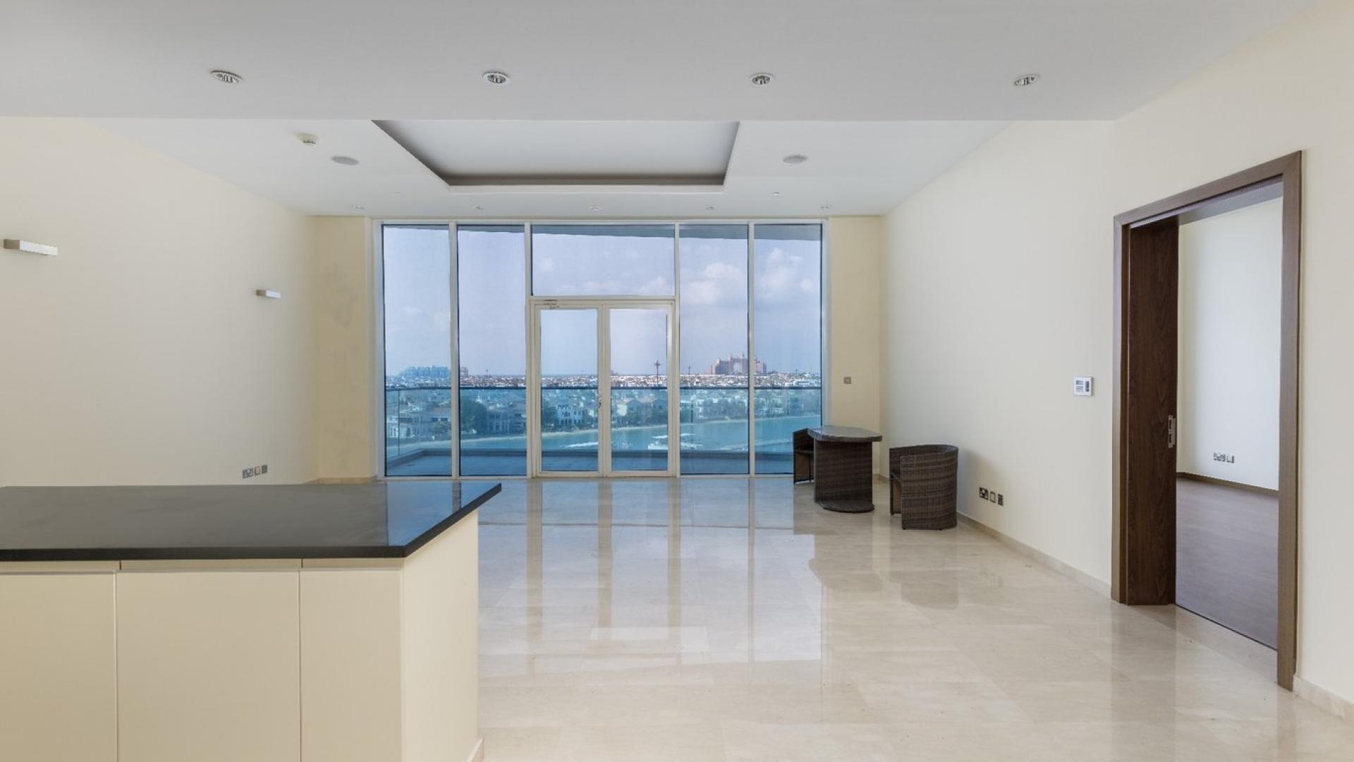 Open-plan kitchen and living area with ocean views in Palm Jumeirah apartment for sale