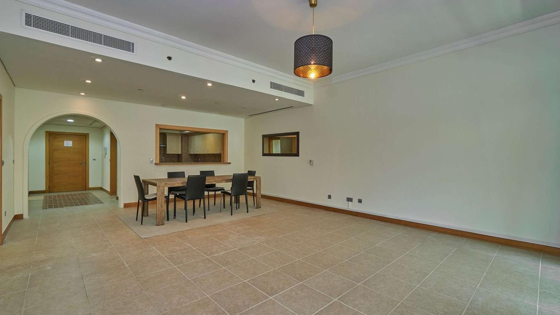 Dining area in beachfront apartment, Palm Jumeirah Shoreline, featuring modern decor and natural light